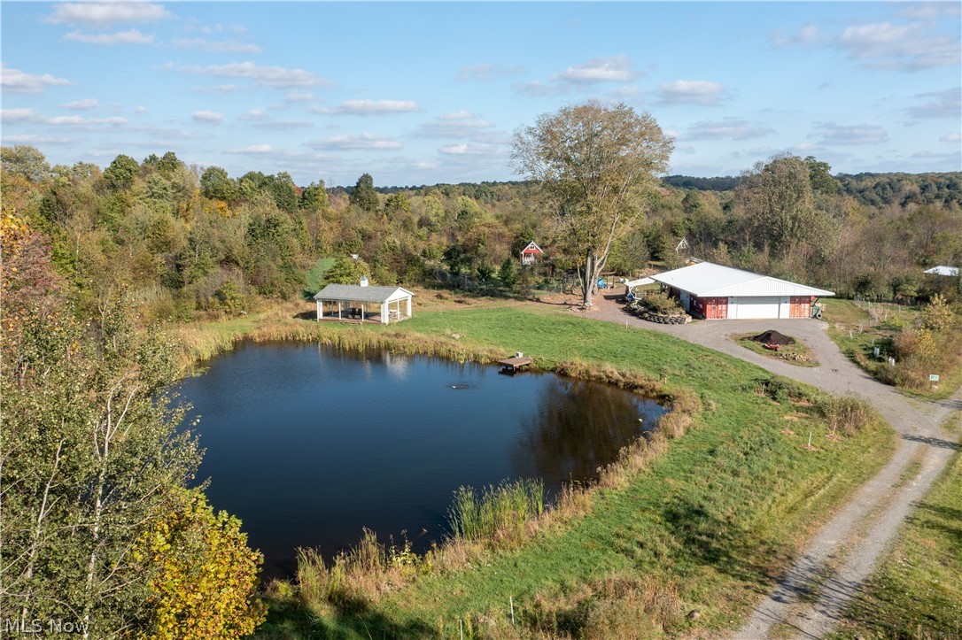Here's an extraordinary opportunity to own Bending Oak, a 23-acre permaculture farm, meticulously designed to foster a harmonious relationship between nature and sustainable living. At the heart of this enchanting property is a 1,200 square foot barn constructed from 20-foot recycled shipping containers, serving as a central hub for all farm activities. There is also a picturesque half-acre stocked pond with a fully-functioning ecosystem and an additional 0.10-acre stocked pond. With a solar-powered gravity-fed irrigation system and rainwater-harvesting cisterns, this farm exemplifies eco-friendly practices, ensuring every drop of water is used efficiently for cooking, showering and irrigation. This property is not just a farm; it's a lifestyle. Four charming tiny houses and 15 campsites invite visitors to immerse themselves in the tranquil beauty of the land, offering unforgettable overnight stays that connect them with nature. A shower house offers 2 showers, 2 sinks and 2 composting toilets, guaranteeing a comfortable stay. Fruit, nut and berry orchards, as well as an annual garden and a hoop house, are already established. Also growing on the farm is an experimental rice paddy, cranberry patch, gingko, ginseng and a variety of other unique plantings. An additional cabin serves as an educational center, perfect for workshops and community gatherings focused on sustainable practices. With over a decade of dedicated work already established, the new owner has the chance to continue this legacy as an agritourism business, a homestead, or to reimagine the property for new ventures.  Whether you're looking to cultivate your green thumb or own a fantastic rural retreat where you can fish, ride, explore and unwind with your friends and family, this is it!