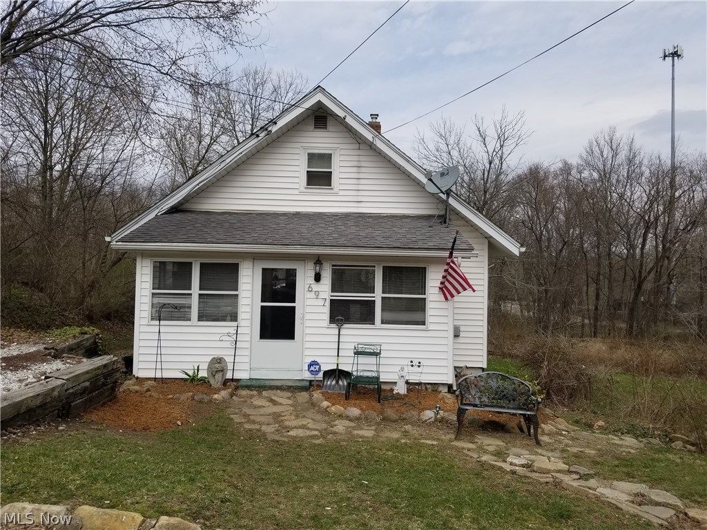 Inviting Cape Cod with 3 City Lots located at the end of dead end street w/ 3 bedrooms and 1 bath.  Pergo floors adorn the spacious and inviting living/dining room with a wood burning stove. Laundry with nature stone floors and glass block windows, located in the walkout basement that has 1 bedroom, workshop area and 1 car garage. Dining room with wood burning stove gives access to a 24x14 wood deck that over looks the very spacious 3 city lot back yard with 2-12x8 storage sheds. Large Sunny Enclosed front porch greets you as you enter this adorable New home you can call your own!!!