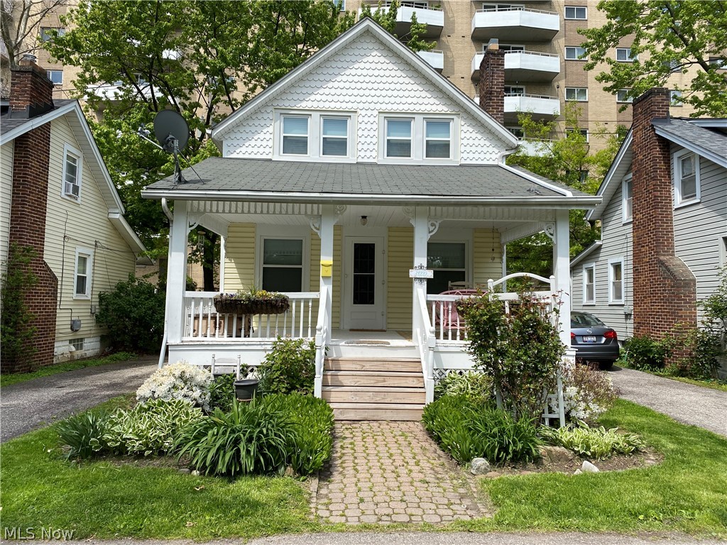 Are you looking for your very own fairy tale home? Or perhaps an easy income generating investment property? This sweet cottage is it! It's loaded with charm, located on a private street and steps away from Lake Erie. The huge, inviting front porch is the perfect place to enjoy a Cleveland summer day/night. Enter into a spacious, light filled living room with original hardwood floors and freshly painted fireplace, which opens to the dining room and kitchen. Kitchen has been updated with new quartz countertops, painted cabinets, flooring and stove. All appliances stay! Upstairs you'll find two bedrooms (front large bedroom can be converted back to two rooms as it once was) and a full bath with a refurbished clawfoot tub. Basement with vented glass block windows houses laundry, utilities, and plenty of storage. Additional updates to the house include all new windows & blinds, Simply Safe alarm system, updated electrical, and new ceiling in living room.  This quiet, private street feels l