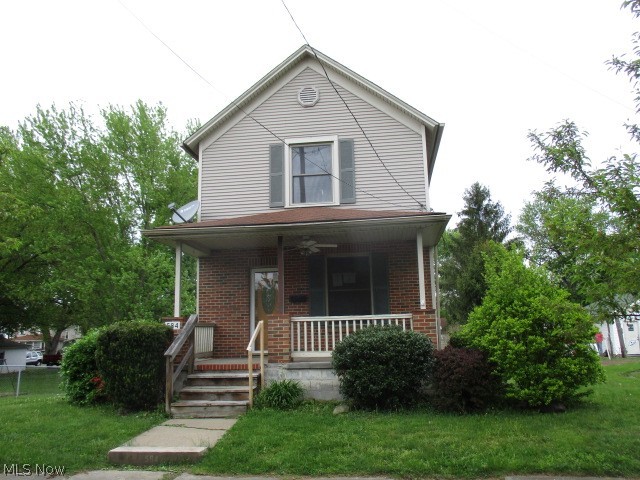Vinyl sided 2 story with cozy front porch, large rear deck with walk out basement, central air and detached garage.