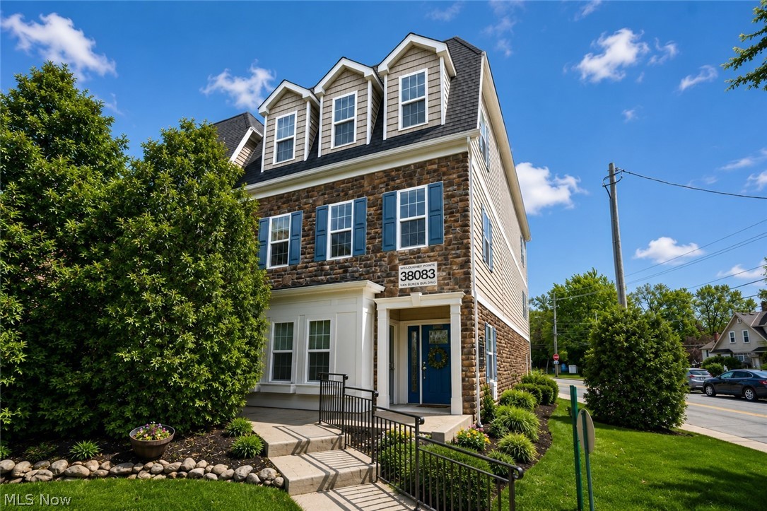 Popular Willoughby Pointe Condo in the heart of Historic Downtown Willoughby! This stunning three-level Brownstone blends timeless architectural character with modern luxury and quality craftsmanship rarely seen today. Built in 2015, this beautifully appointed townhome features 9’ ceilings, an open floor plan, and private elevator access to all levels, along with dramatic touches! The spacious main level offers hardwood floors, recessed lighting, a formal dining or sitting area, a private office, and an inviting great room with gas fireplace featuring tile surround and wood mantel. The gourmet kitchen is designed for entertaining with custom cabinetry, large center island with breakfast bar seating, pantry, eating area, and all appliances included. French doors open to a private rear balcony porch—perfect for morning coffee or relaxing evenings outdoors. Upstairs, the luxurious owner’s suite features a huge walk-in closet and private bath with dual vanities and a custom tiled shower. Two additional bedrooms, 2.5 baths, and conveniently located second-floor laundry complete the home. Additional highlights include an open staircase with striking stone feature wall, attached 2-car garage, guest parking, and move-in-ready condition with exceptional attention to detail throughout. Enjoy maintenance-free living just steps from all that Downtown Willoughby has to offer, including restaurants, coffee shops, shopping, the library, summer concerts, festivals, and the farmer’s market. Experience the perfect blend of comfort, character, convenience, and vibrant downtown living at its finest!