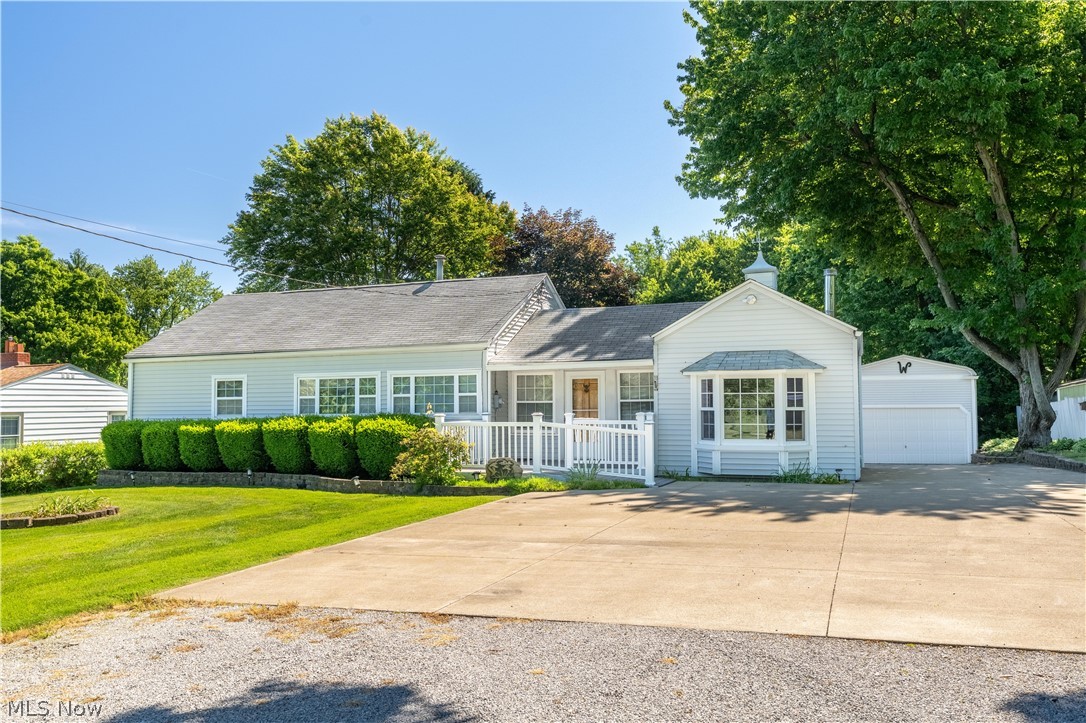 Welcome to this charming ranch-style home, perfectly situated on 1.53 private acres and offering over 1,600 square feet of warm, inviting living space. A welcoming front porch sets the tone as you step inside to a cozy, cabin-inspired dining room, where rich wood paneling and rustic charm create an instantly comfortable atmosphere. Just off the dining room, the spacious family room features a wood-burning stove, vaulted beamed ceilings, and a beautiful bay window that fills the space with natural light. An expansive great room connects to the sitting area, providing the perfect setting for large family gatherings, celebrations, or everyday living. The kitchen offers generous counter space, a tile backsplash, and direct access to the oversized back deck ideal for morning coffee, outdoor dining, or entertaining guests. The peaceful backyard is surrounded by trees and features plenty of green space, a charming storage shed with its own mini porch, and a fire pit area perfect for relaxing evenings with family and friends. Down the hall, you'll find three comfortable bedrooms and two full bathrooms, including a spacious primary suite. The main bath features a tiled tub/shower combination and convenient hallway linen storage. The primary retreat offers a walk-in closet, private deck access, and an updated ensuite bath complete with a tiled walk-in shower and additional storage. The lower level adds even more versatility with a dedicated laundry area and a finished recreation room perfect for hobbies, movie nights, a home office, or additional living space. Completing this exceptional property is a detached three-car garage with a workbench, a separate RV garage, and ample front parking for added convenience. This home is one you won't want to miss. Schedule your private showing today!