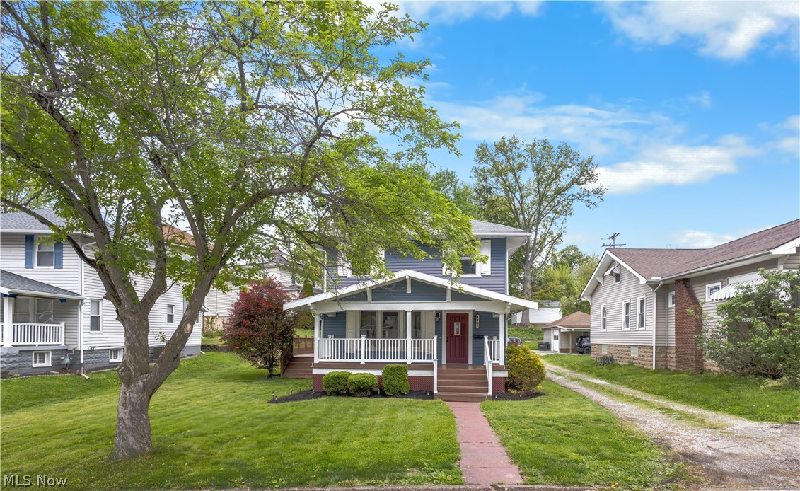 Welcome home to this move-in-ready 3-bedroom, 1.5-bath home offering timeless character, functional living space, and inviting outdoor areas. Step inside to find beautiful original woodwork, built-in cabinetry, and a stunning stone fireplace that serves as the centerpiece of the spacious living room. The bright eat-in kitchen offers stainless steel appliances, abundant cabinet space, and easy access to the expansive wraparound porch—perfect for morning coffee, outdoor dining, or entertaining guests.

The main floor features convenient laundry and a half bath, while upstairs you'll find three comfortable bedrooms and a full bath. A full basement provides plenty of storage space and room for hobbies or a workshop.

Outside, enjoy both a covered front porch and a large wraparound porch overlooking the side yard, creating multiple spaces to relax and unwind. Additional highlights include central air, gas heat, public utilities, and all kitchen appliances plus washer and dryer conveying with the sale.

Conveniently located near schools, parks, shopping, and everyday amenities, this home is ready for its next owner to move right in and make it their own.