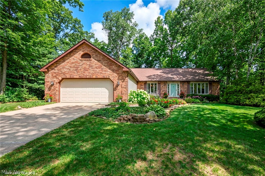 Welcome to this stunning ranch home tucked away on a quiet cul-de-sac in desirable Concord Township, offering the perfect blend of luxury, comfort, and privacy. From the moment you enter inside, you’ll appreciate the fresh updates throughout including newer carpet and a fresh coat of paint that create a bright and inviting atmosphere. The remodeled gourmet kitchen is truly the heart of the home, featuring abundant granite counter space, stainless steel appliances, a beautiful pantry, a stylish coffee bar, and a spacious eat-in dining area, perfect for everyday living and entertaining alike. The home offers a versatile layout with both a formal living room and dining room, as well as a large great room with a cozy fireplace and sliding doors leading to a relaxing three-season room. The main level includes three bedrooms and two full bathrooms, highlighted by an incredible owner’s suite with private sliding doors to the Trex deck, a massive walk-in closet, and a beautifully remodeled en-suite bath with gorgeous tile finishes. The other bedrooms are also great sizes with double wide closets! Convenience is key with first-floor laundry and an attached two-car garage. The fully finished lower level dramatically expands your living space, featuring a full bar, spacious recreation area, and two additional bonus rooms perfect for guests, offices, or hobbies. There is also a full bathroom and a dedicated workshop/storage space! Discover your own private outdoor oasis in the serene, wooded backyard offering exceptional privacy with a tree lined lot with no noticeable neighbors, a spacious deck, a charming stone paved patio, and two huge sheds! This tranquil setting feels like a retreat. With pride of homeownership throughout, additional updates include roof (2010), HWT (2017) and newly painted garage and shed. Situated on a highly sought-after cul-de-sac lot, this exceptional ranch offers the perfect balance of elegance, space, and natural beauty in one remarkable home.