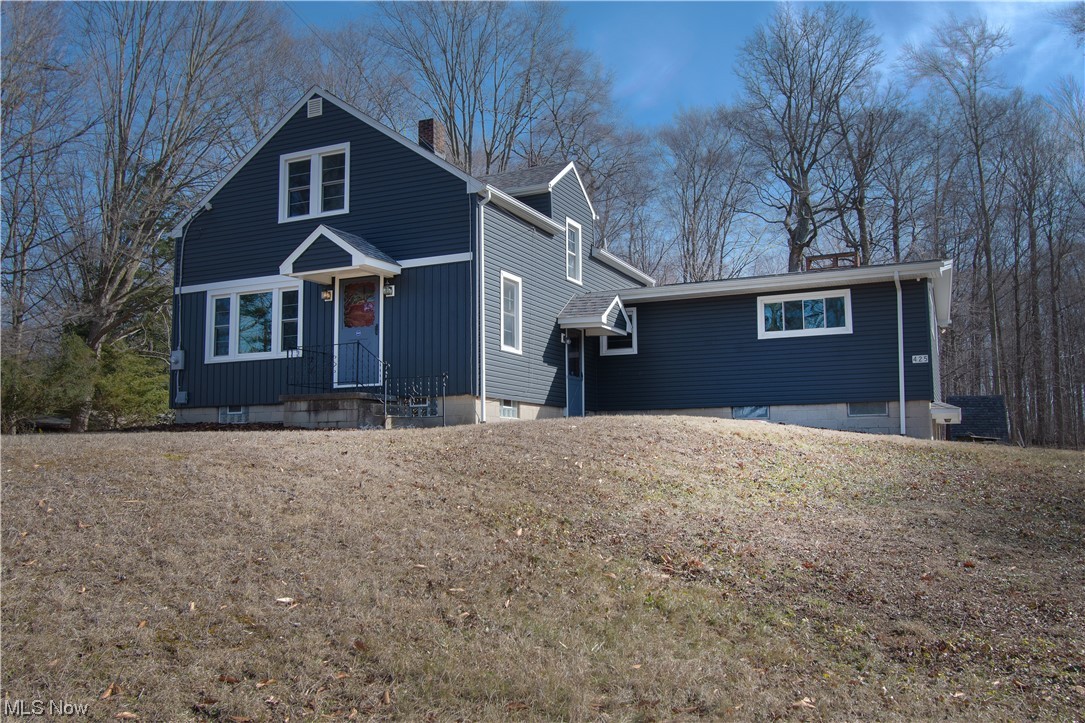 This spacious bungalow sits on a beautiful three-acre lot in Marlington school district. As you enter this beautifully updated home, you will love how bright and airy it is. The first floor has a lovely family room with laminate flooring and modern colors, two bedrooms, a full bathroom, an adorable kitchen, and a spacious great room with a brick wood-burning fireplace and access to the back porch. The private backyard has beautiful wooded views perfect for relaxing during warm summer days. Enjoy family time in the recently updated kitchen with stainless steel appliances, white cabinets, and counter space accented with a subway-tiled backsplash. Upstairs you will find two more bedrooms with new carpet and built-in storage. This home is complete  with a laundry area and an attached 2-car garage. Updates include new floors throughout, freshly painted, new appliances, updated kitchen, etc. Don't miss it, and make an appointment for your private showing today!