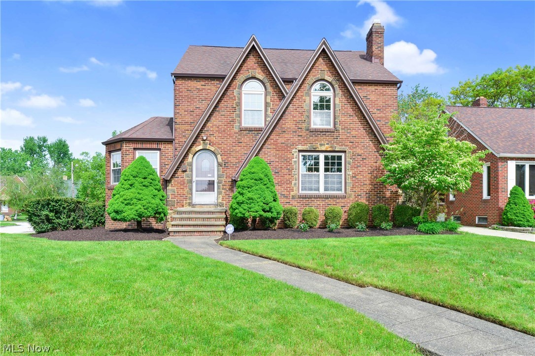 Prepare to be Moved! Into this charming yet modern English Tudor style home in Parma. You'll be welcomed into the large Living Room with brick fireplace that opens to formal Dining Room w/ built-in Hutches. Beautiful octagon Library/Den with built-in shelving is located just off the Living Room. Everyone will enjoy cooking in the updated eat-in Kitchen with tall, glazed cabinets and bay window eating area; the perfect place to enjoy your morning coffee. Updated 1st floor half bath completes this level. Upstairs, you'll find 3 bedrooms and a remarkable bathroom with separate bath and shower in addition to beautiful unique floor tiling. Finished 3rd floor is a Bonus opportunity for additional bedroom, playroom or hobby room! Downstairs, everyone will love gathering in the Recreation Room which features a fireplace and built-in wet bar. Additional utility / Laundry area and glass block windows throughout basement. Outside, relax in the beautifully landscaped yard with large decorative pat