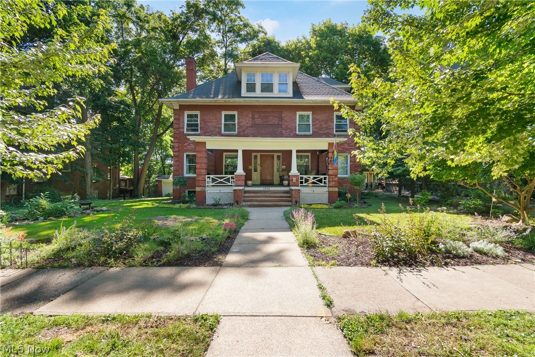 Welcome to this stunning brick-front porch colonial, a true 1920's gem nestled in the heart of Cleveland Heights. Offering over 2,700 sq ft of charm and character, this home blends timeless craftsmanship with thoughtful updates, all just steps from Coventry’s vibrant shops, restaurants, and minutes from University Circle’s cultural landmarks. From the moment you step inside, you’ll be captivated by the architectural details—gleaming inlaid hardwood floors, elegant French/glass pocket doors, and an open staircase that spans all three levels. The spacious foyer invites you in, leading to a warm and inviting living room boasting a wood fireplace serving as the centerpiece. The formal dining room, framed by stunning glass pocket doors, and a modern chandelier is the perfect space to gather for special occasions. The kitchen is a chef’s dream, recently renovated with brand-new cabinetry, quartz countertops, high-end, stainless steel appliances, and a striking 36-inch copper sink complete with a built-in cup rinser. Adjacent to the kitchen, a charming three-season sunroom and a 1st floor office provides peaceful retreats, while a rear deck overlooks the private, wooded backyard—ideal for morning coffee or evening relaxation. Upstairs, four generously sized bedrooms offer comfort and versatility. The primary suite features a walk-in closet and an en-suite bath. Two additional bedrooms share a classic bathroom while the fourth bedroom boasts its own private balcony. The 3rd floor is ready for your finishing touches in this flexible living space, including an extra bedroom, a bonus room, and a full bath with a vintage clawfoot tub. Recent updates include refinished original pine floors, upgraded plumbing and electrical in key areas, and a refreshed entryway. This home is brimming with potential, offering the perfect blend of historic charm and modern convenience. Seller is selling AS-IS. Don’t miss this opportunity to make it your own! Begin your story here!
