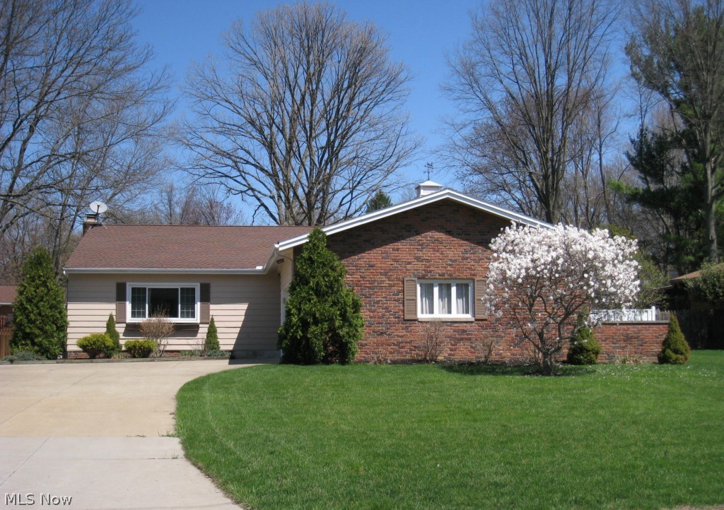 Wow! FABULOUS 3 bedroom 2.5 bath split level.  Big beautiful maple kitchen with upscale cabinetry, rich granite counter tops, gorgeous buffet and matching maple bench w/coat rack and wide plank maple flooring.  An open staircase overlooks the spacious cathedral living room.  A few steps down leads to the 30' family room with a stone fireplace.  The second kitchen/workshop/laundry area is a great space for your personal hobbies.  A fantastic sun porch surrounded by windows overlooks the 2 level patio and large private lot.  Nice master suite with full bath.  Major updates include new windows and roof in 2005, updated master bath, guest bath, totally renovated sun porch, updated kitchen, paint, carpet and so much more.  Larger than it looks...an absolute must see!
