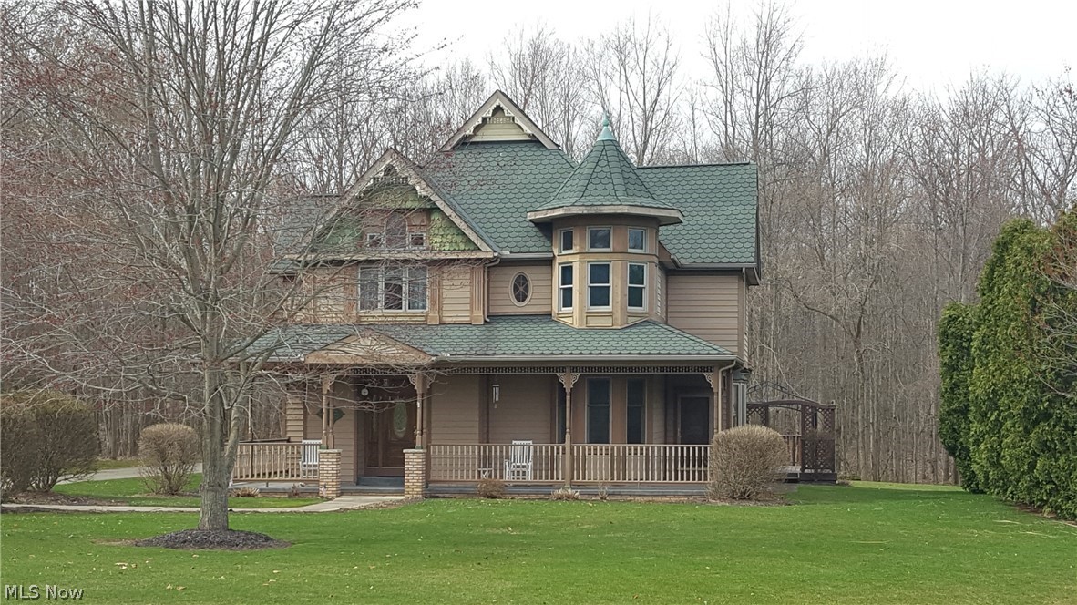 Step back into time with this beautiful, 3,760 sq. ft. Victorian style home with attached three car garage on a two acre cul de sac. Quality Custom built home with 3 sided, wrap around front porch, 20 x 30 rear deck with wooded back lot.  Oak trim throughout plus gourmet kitchen with fireplace, exiting to sun room, and first floor laundry.  Full size dining room with new carpeting with china cupboards and window seat. Family room has fireplace with new carpet. First floor office has oak crown ceiling could be used as a bedroom. Second floor Master bedroom with spiral staircase to loft, currently used as a work out area, could be used as office or studio.  Private master bath with glamour bath and see through gas log fireplace. Full finished basement with wet bar and half bath. Finished room could be additional bedroom or office. Basement also has crawl space and walk out access to garage.  Additional laundry available in basement. Space about garage has separate access and could be eas