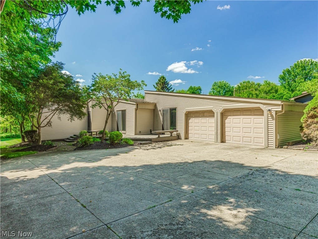 Spectacular Mid-Century Modern Ranch is located at the end of a lingering secluded tree lined drive.  Placed in the center of a magnificent 1-acre lot, this is the perfect home if you prefer unique. Boasting the original wide planked wood flooring, beamed vaulted wood ceilings, 3 large bedrooms and updated bathrooms and kitchen. A slider from the kitchen leads to a private deck.  All stainless-steel appliances remain. A formal dining room is located off the kitchen and includes transom windows for maximum sunlight. The great room features an eye-catching mid-century fireplace and a wall of windows that leads to the expansive deck. The hot water tank, water softener, and carpet in all three bedrooms have just been replaced.  An oversized garage and shed means room for all your outdoor equipment. Lots of extra parking for your big summer parties on this beautiful lot!!!!!  Price is right in Tallmadge. Call for your private showing today.
