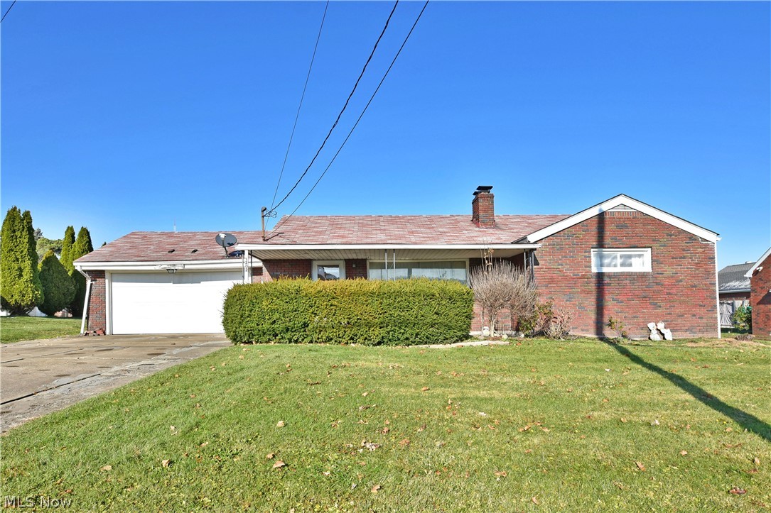 This 3 bedroom, all brick ranch is perched on a double lot and is packed with potential just waiting for you! A large covered front porch welcomes you as you approach the home. Step inside and take note of the low maintenance wood look laminate flooring and large wood burning fireplace! The dining room flows seamlessly with the living room and showcases access to the rear covered patio and backyard. The kitchen is wide open to the dining room and has gorgeous original hardwood cabinetry, breakfast bar seating, and ceramic tile flooring. Head down the hall to find a full bath and 3 generously sized bedrooms with ample closet space! The lower level of this home has an awesome rec room for more living space with a built in bar and pool table! Another full bath, laundry services, mechanicals, and storage finish out this level. The attached 2 car garage is slightly oversized allowing for additional storage or workspace. What are you waiting for? Call today for your personal tour!