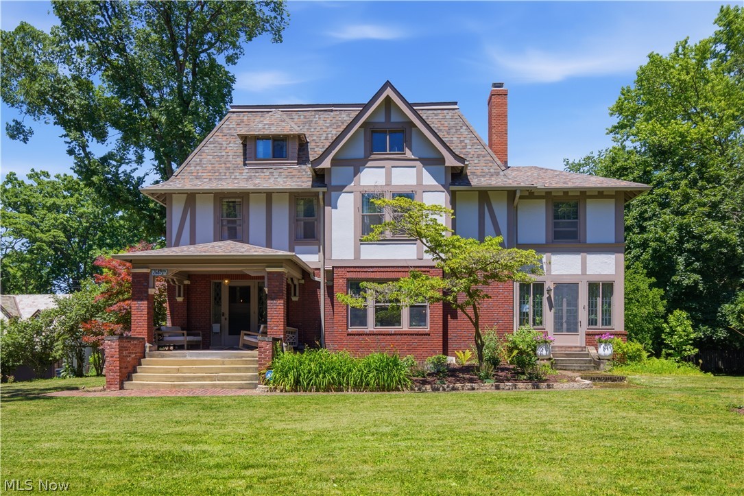 Welcome to 2689 Berkshire Road, a stunning Tudor Revival built in 1915, blending timeless architecture with thoughtful modern updates. Designed by renowned architect Franz C. Warner, who also designed Roxboro Elementary, Cleveland Heights High School, and others, this nearly 4,800 sq ft, seven-bedroom home showcases exceptional craftsmanship, historic charm, and incredible character.
A welcoming covered front porch leads to a grand foyer featuring rich woodwork, 9 ft ceilings, gleaming hardwood floors, and an impressive wrought iron stair railing with a lighted statue. The spacious living room offers a marble fireplace and window bench, opening to a sunroom currently used as an office. The formal dining room features another fireplace and French doors leading to a sitting room and screened porch overlooking the fenced backyard.
The renovated kitchen (2025) combines style and function with quartz countertops, gas range, pot filler, island, beverage cooler, pantry, abundant storage, and breakfast nook. The second floor offers four bedrooms, two full baths with heated floors, and a remarkable primary suite with fireplace, wardrobe room, and morning sunroom. The third floor adds three additional bedrooms, full bath with claw foot tub, and a storage room.
Enjoy nearly an acre of park-like grounds with mature landscaping, pergola, and private fenced backyard. The newer three-car garage includes a unique kids’ climbing corner. This home also features solar panels providing added energy efficiency. Recent updates include a new roof (2024), concrete driveway (2024), rebuilt front chimney, new chimney caps, and hot water tank (2026).
Ideally located within walking distance to Coventry and Cedar Fairmount, this Cleveland Heights gem offers a rare opportunity to own a historic Tudor Revival with modern comfort and unmatched charm. Don't miss out, schedule your private showing today!