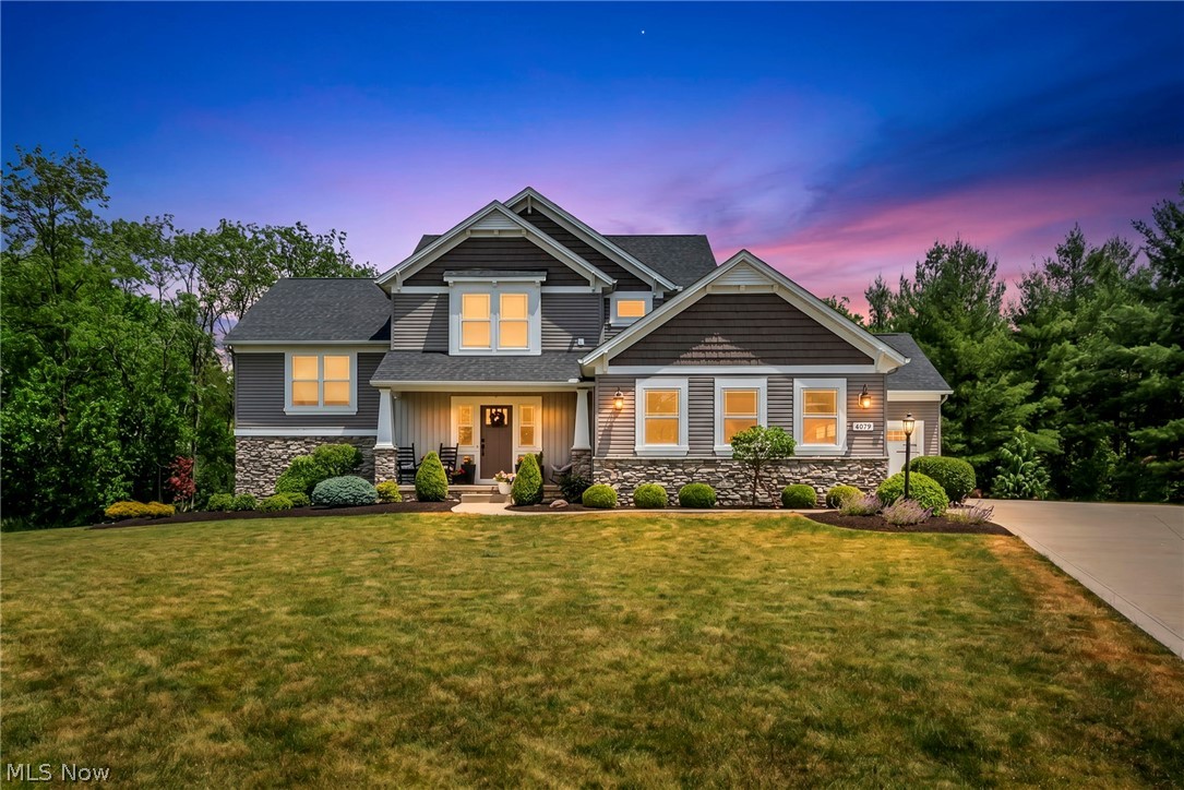 Welcome to this multi-level craftsman home that has it all and then some, including space for an in-law suite, entertaining, and relaxation, all while feeling warm and welcoming. On the main floor is a spacious entryway with half bath, a mudroom with built-in bench and shelving and coat closet. The open concept kitchen, complete with beautiful cabinetry and finishes, includes an island with seating area, granite countertops, and a corner pantry. The open family room has gas fireplace and expansive windows for plenty of natural light. The dining room with chandelier is surrounded by more windows, a vaulted ceiling, and sliding doors that open up onto your second-story composite deck which is partially covered and has two gas hook ups for a grill and fire pit. Back inside, heading halfway downstairs sits a large family or recreational room, with space big enough for a pool table and sectional couch. The rec room has glass sliding doors that walkout to the backyard hot tub area. The finished walkout basement is perfect for a guest suite, mother-in-law apartment, or college age student living at home. It has a secondary full-size kitchen with stunning cabinets and granite countertops, a spacious living room with walkout to the back yard, a secondary laundry room, bathroom and bedroom. This space is a complete apartment, including a separate private entrance off of the third garage bay. The second level of the home contains the primary suite, with custom built walk in closet and bathroom with double vanity, separate water closet, and walk in shower. On the top floor, there are three additional spacious bedrooms, a bathroom with double vanity and separate toilet and shower, and a full size laundry room. The .81 acre lot is private and secluded, surrounded by woods. The deck, walk-out patios, hot tub area, and ample yard space make this home the complete package! Everything you need, all in one property. Schedule your showing today.