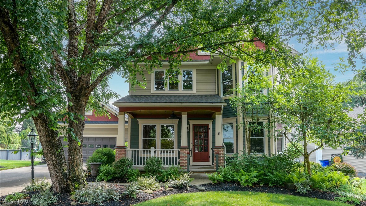 Experience timeless elegance with the comfort of modern construction in this stunning Victorian-inspired home. Thoughtfully designed with exceptional craftsmanship, the home features handcrafted moldings, 10-foot ceilings, and ample windows that fill the home with natural light.
Relax in the large living room, or enter the Parlor, ready for relaxing, a home office, or additional living space. Custom built-in bookcases, an antique faux fireplace, and large bay windows overlook the neighborhood. The dining room is perfectly suited for both large and small gatherings. The laundry/mud room is tucked away and provides convenient entry from the oversized attached two-car garage. The kitchen features custom cabinetry, room for a table, and two pantries. The first floor primary suite includes a huge walk-in closet, an en-suite bath complete with a soaking tub and separate shower. Upstairs, you’ll find three additional bedrooms, a large open landing perfect for a reading nook or office, and full bathroom. 
The expansive basement provides abundant storage and additional living potential, complete with a full bathroom and a wide walk-up staircase leading directly to the attached two-car garage.
Outside is a gardener’s paradise. Mature trees, lush landscaping, and professionally designed hardscaping create a private retreat. Relax on the inviting covered front porch, complete with a ceiling fan for warm summer days, enjoy the spacious covered back porch, or bask on the brick patio surrounded by gardens. 
Updates include: Roof (2017), some Hardie Board siding and fascia replaced (2017), Gutters with LeafGuard (2022), Furnace/AC (2023), First floor carpet replaced (2021), kitchen updates by Hartville Hardware including countertops, backsplash, and sink (2015), Refrigerator (2023), Fire/Carbon Monoxide detectors (2026).