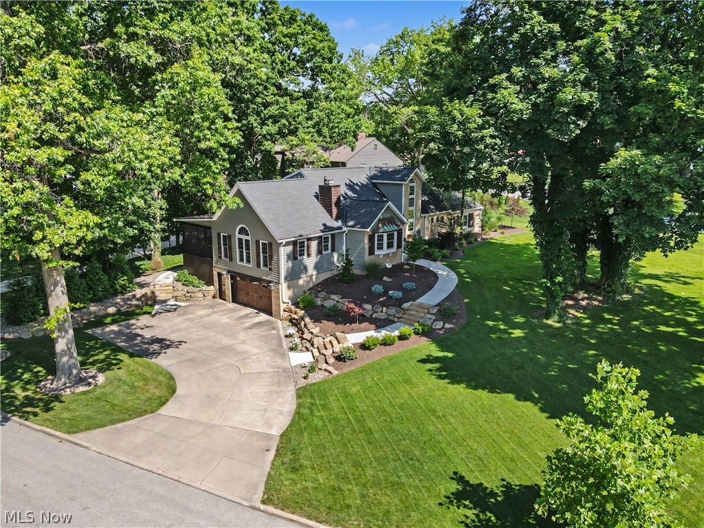 Located in the center of Silver Lake Estates is a truly unique and original Cape Cod home. Its manicured landscaping, soaring windows and grand staircase in the foyer make a stunning first impression. This 1952, 3 bedroom 2 full and 2 half bath home has been completely updated over the last few years and allows for daily first floor living. Off of the foyer, pocket doors lead into a spacious dining room that contains a two sided fireplace that is shared with the great room. The dining room, with a boulevard facing bay window, exudes a cozy atmosphere and is perfect for entertaining and gathering with friends and family. French doors open into a fully equipped and recently updated gourmet kitchen that overlooks into the beautiful sundrenched great room with a soaring vaulted ceiling, two sky lights and a natural stone fireplace. With the bright windows, hardwood flooring and an open, airy atmosphere it feels like you are living in a treehouse. Another set of French doors lead into the recently added screened in porch overlooking the lush landscaping and firepit area giving a sense of peace and tranquility. In addition, there is ample storage that is easily accessible under the screened porch. Further enhancing the first floor living is a grand primary suite that contains a second fireplace, updated ensuite, walk in closest and laundry room. Upstairs you will find two large bedrooms that share a fully remodeled bathroom. The lower level consists of a finished recreation area, half bathroom, two storage areas and access to the two car garage. This spectacular home offers lake privileges and has so much more to offer. Set up a showing today and picture yourself living in the heart of Silver Lake.