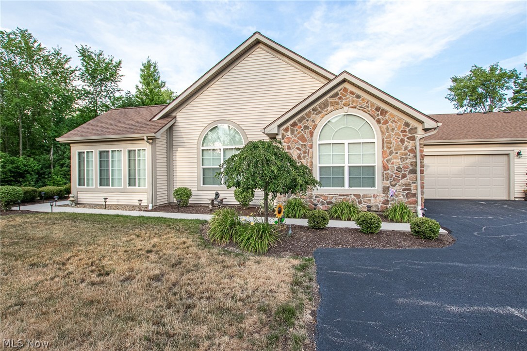 Looking for carefree living at its finest? Then look no further than The Crossings at West Valley, a maintenance free community located in Brunswick Hills. This lovely 3-BR, 2-full bath Cluster Ranch offers a very open floor plan with 1991 square feet of living space. Notice the upgrades - high cathedral ceilings & lovely upgraded luxury laminate flooring run throughout this beautiful home. The kitchen is open to the dining area & great room. You will love cooking in this spacious kitchen! The cabinets were upgraded to the Spring Valley Maple Cabinets. In addition, there is granite countertops, mosaic tile backsplash, cabinet under lighting, ample counter space & storage. All appliances stay. The large great room has a vaulted ceiling, gas fireplace with ceramic tile & tons of natural light. Off the great room you will find the 4-season room perfect for relaxing in the evenings as you enjoy the views of the secluded wooded lot. The large Master Bedroom with vaulted ceiling is the perfe