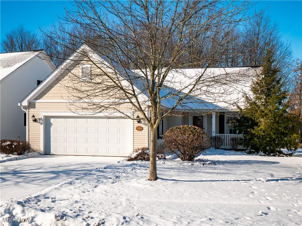 You're not going to want to miss this fantastic Ranch style cluster home in Cinnamon Lakes!  This home sits on one of the most desirable premium lots in the development, with a gorgeous view of the pond and wooded wetland preserve off the home's back deck.  From the cozy covered front porch and gorgeous landscaping you can't see at this time of year, to the forward facing garage, this home was thoughtfully designed by it's original owners. This beautiful, well-cared for home boasts an open floor plan with an upgraded west-facing sunroom with wall of windows and slider to the tiered deck.  The spacious, centrally located family room features vaulted ceilings and a gas fireplace flanked by buit-in shelving.  All of main floor was freshly painted in 2020.  A formal dining room, open to the kitchen allows space to entertain.  Kitchen & dining room wainscoting and backsplash added in (2020) a new faucet in (2022), new microwave and range (2023) added as well.  2 bedrooms are on the main floor, including a large master, with huge walk-in closet and remodeled master bathroom with gorgeous shower in (2019). The second bedroom, near main bath is a great size with a nice nook for furniture. The laundry room is on the main floor (washer/dryer stay)!  Downstairs, you'll find an amazing finished basement with lots of extras.  Lots of space to entertain in the open area, a 3rd bedroom/office or hobby room with egress is also great for the overnight guests.  This third room has built-in cabinetry and storage along with a current sewing closet, which makes for a true, multi-purpose room.  A full bath, private workshop room and utility/storage room, round out the lower level.  There are way too many features to mention that you'll fall in love with. New roof  (2021) and K Guard Clog Free gutters on entire home (2018).  Irrigation system in front and back yard and 2026 servicing records for mechanicals. Enjoy a beautiful community where snow removal and lawn care is included $170/mo.
