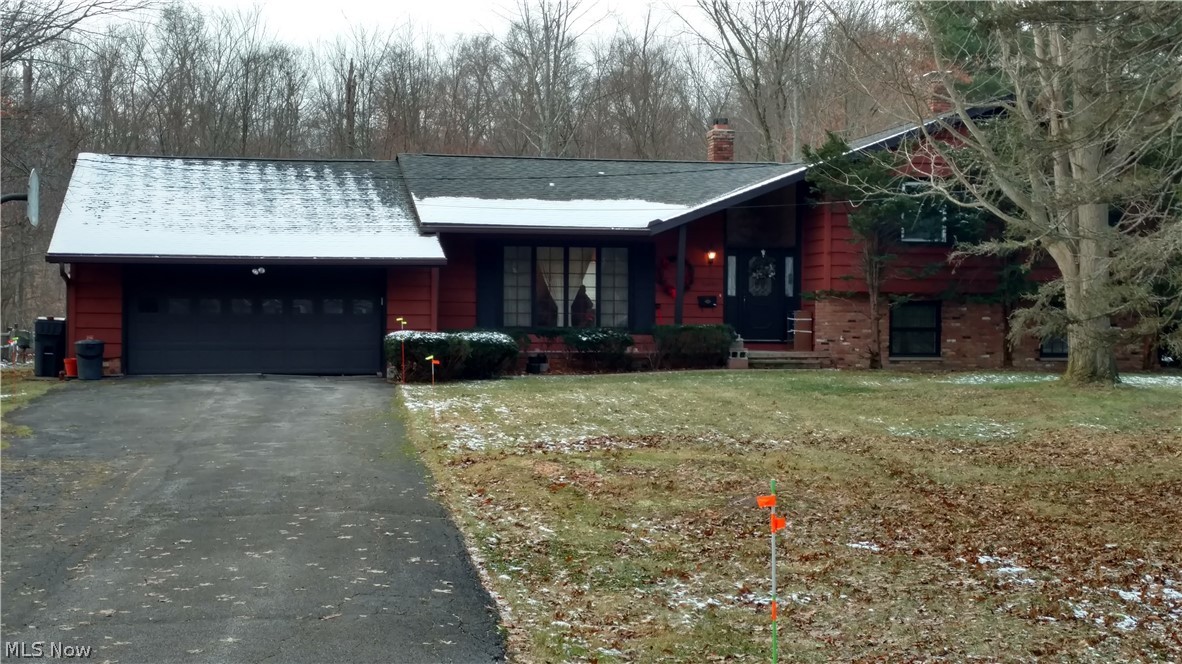 Location, spacious, enclosed porch, walk-out family room, and almost one acre of peaceful! BEST words to describe this 3 bedroom, 2 1/2 bath split. This home is ready for your personal palette of color, placement of your favorite pieces of furniture, art and a call to your favorite landscaper for the perfect design for this wooded private lot.The vaulted foyer opens to the living room, dining room(with new carpeting in 2018) and flows in to the eat-in kitchen.Updates to the kitchen include new floor, backsplash, newer appliances, Corian countertop and sink. A slider door in the kitchen takes you to the enclosed porch that steps down to the backyard.The second level master bedroom has an en-suite bath with walk-in shower, two additional bedrooms with great closet space and main bathroom. And YES, there is a clothes shoot.The lower level family room features a brick wood burning fireplace with heat insert, 1/2 bath, laundry room and the walk-out to the backyard. The extra large two car g