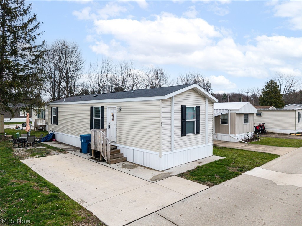 Welcome to this well-maintained and thoughtfully updated 2-bedroom, 1-bath manufactured home located in the Northridge Cove community in North Ridgeville. Offering 768 square feet, this home features an efficient layout with a central living area that flows seamlessly into the kitchen, maximizing functionality and use of space.
Bedrooms are situated on opposite ends of the home, providing separation and privacy, with each offering ample closet space. The main living area connects to the kitchen and continues toward the full bathroom, with convenient first-floor laundry located just outside the bathroom area. The primary bedroom is positioned just beyond for easy access.

Recent updates include roof (2022), furnace (2022), air conditioner (2025), hot water tank (2022), oven (2022), refrigerator (2024), disposal (2022), dishwasher (2022), washer (2024), and dryer (2024).

Exterior features include a designated parking space and an outdoor area currently set up as a patio, suitable for a variety of uses.

Northridge Cove offers convenient access to shopping, dining, and entertainment, along with nearby outdoor recreation including Bradley Woods Reservation and Bunns Lake Wildlife Area. Community amenities include a playground, barbecue area, pet-friendly environment, on-site management and maintenance, landscaped grounds, and well-lit streets. Easy access to U.S. Route 20 and Interstates 480 and 80 allows for convenient travel throughout the area.