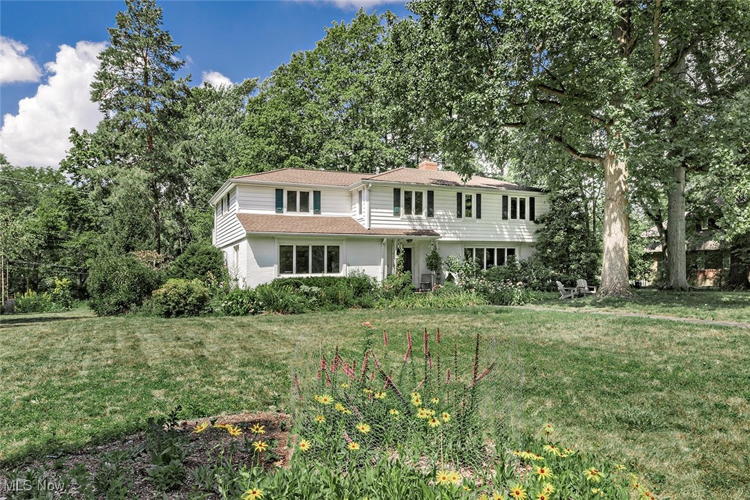 Step into this beautifully maintained 5 bedroom mid-century colonial in a desirable neighborhood of Shaker Hts. Inside, you'll find spacious, light-filled rooms with beautiful hardwood floors. The updated kitchen offers stainless steel appliances, granite countertops, a natural stone backsplash, and ample cabinetry. The formal living room features a wood-burning fireplace and large picture windows. Let your gatherings flow from the adjoining dining room into the sunroom which offers a serene space to relax year round. Upstairs, the primary suite includes a private bath, accompanied by 4 additional bedrooms and 2 more full baths - providing plenty of space for family, guests, and a home office/flex room. The finished lower level offers a cozy rec room with built in bar, laundry area, and abundant storage. Outside, the backyard features a brick patio and lush greenery - ideal for summer evenings. A two-car garage completes the property. Conveniently located near parks, shopping, and public transportation. This home has so much to offer! Schedule your private showing today.