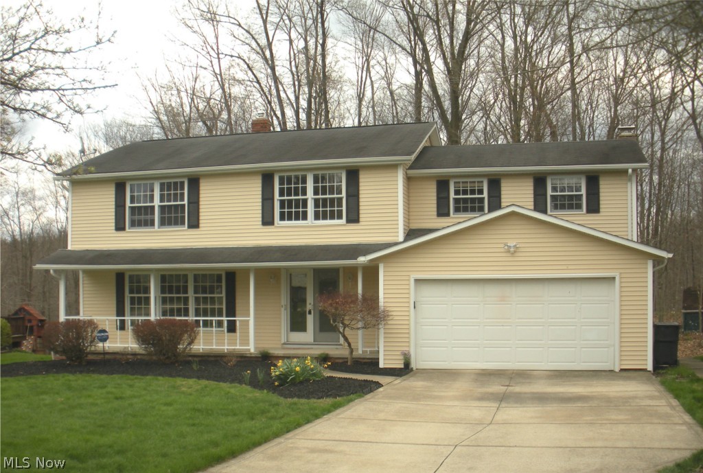 Beautifully updated colonial on a cul de sac street with scenic woods behind it. Home has updated kitchen and baths, newer siding and gutters, fresh paint inside and is ready to move into! Light and bright and neutral.  Both kitchen and family room have sliding doors to the deck and views of the private back yard. Look at the bedroom sizes!  Lower level rec room is additional play or hobby space plus there is storage and laundry!  This is the house you have been waiting for in a very pretty and desireable Solon neighborhood!  WOW!
