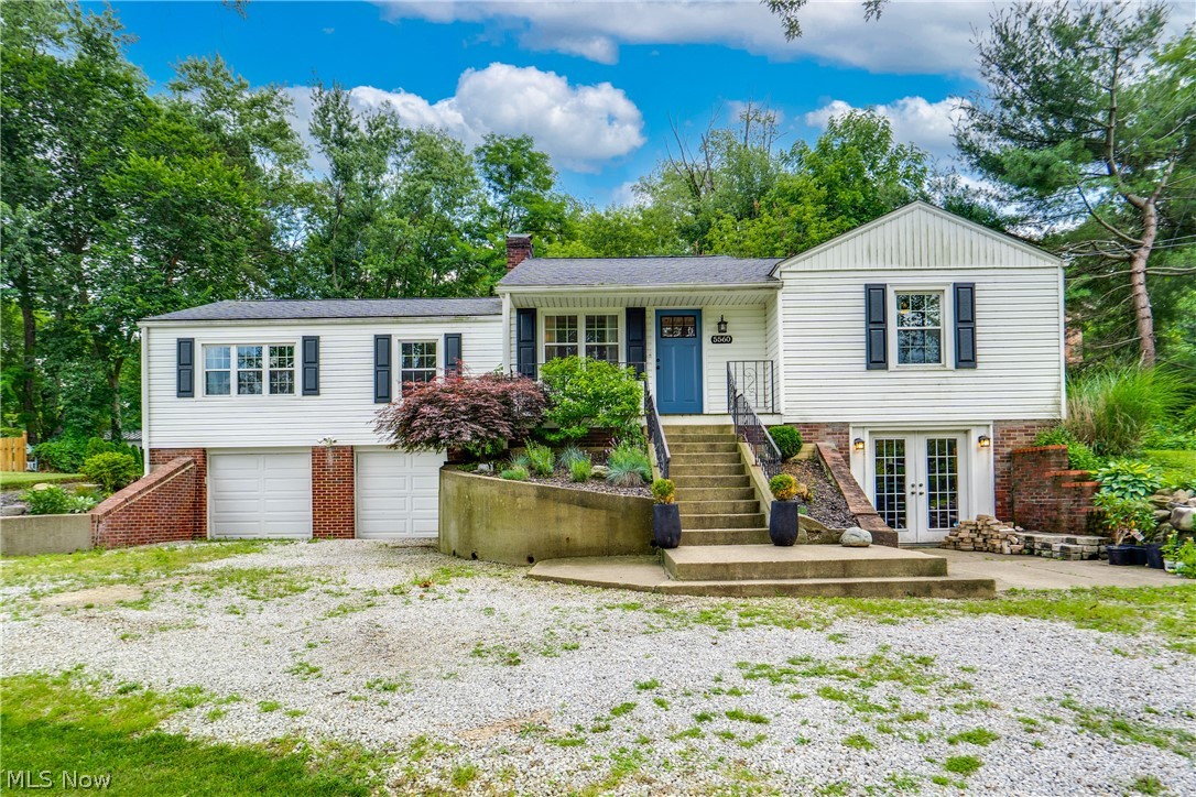 Lake life is calling and this raised ranch at Lake Cable is going to fulfill that dream! Tucked away on nearly three-quarters of an acre of peaceful, wooded land, this 4-bedroom, 2.5-bath home offers the rare combination of space, updates, and lakeside convenience that this Jackson Twp. neighborhood is known for. Step inside and you'll notice the dark bamboo hardwood flooring throughout the home. A beautiful contrast to the dark wood is the lighter glaze finish on the newer kitchen cabinetry. The kitchen is the kind of space that you won't want to leave with a generous 5x8 island with granite top that anchors the room, a corner pantry, and Kitchen-Aid appliances. The open floor plan offers versatility with great space to combine dining, relaxing, and entertaining while keeping everyone together. The home is cleverly divided with the owner's suite, bedroom 2, and the main full bath on one side while bedrooms 3 and 4 are located on the opposite side. Adding more options, bedroom 4 is set up to function as a first floor laundry or keep it as bedroom space. The walk-out lower level has a rec room with bar area, half bath, and an unfinished space which could be the coolest "man cave", flex space, or just a lot of storage. Outside, the lot gives you room to breathe. Trees, privacy, and an expansive patio with pergola and hot tub provide excellent options to relax or entertain. There's an option to secure a dock on the lake meaning summer evenings on the water are just a short walk away.