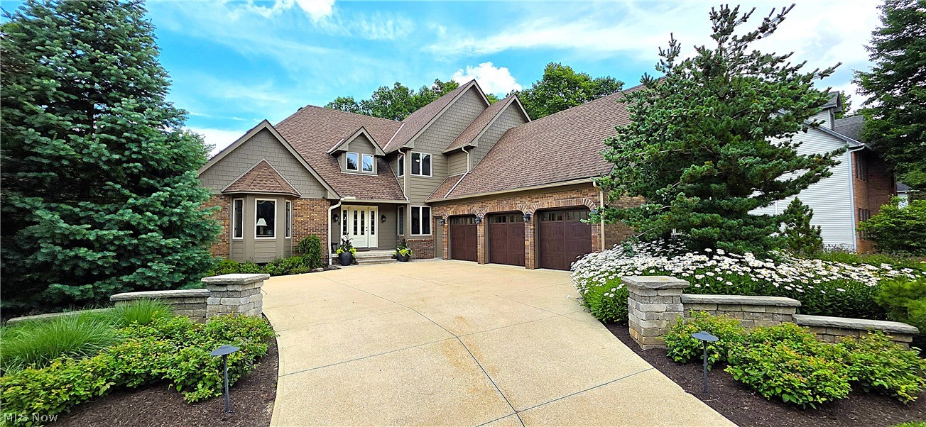 Welcome to this beautifully updated, custom-built move-in-ready home where quality craftsmanship and improvements shine throughout. Not your typical Strongsville property, this rare find backs to a densely wooded common area, creating an exceptionally private backyard retreat.  The remodeled kitchen features granite countertops, updated lighting, and newer appliances. The luxurious primary bath has been completely renovated with a custom tile shower, free standing soaking tub, dual vanities, and premium finishes, while the second-floor bath has also been tastefully updated. The main level showcases engineered hardwood flooring, freshly painted woodwork, newer carpeting, and a remodeled office with custom wainscoting. Additional improvements include the family room with a gas fireplace and remote start, an updated laundry room and front entry, insulated carriage-style garage doors, and a high-efficiency furnace with a Wi-Fi thermostat. Outdoor living is truly exceptional with the professional Award Winning landscaping, a composite deck, hot tub, outdoor fireplace, water features, bar, and a stunning Unilock paver patio with integrated LED lighting—creating the perfect setting for relaxing or entertaining. Truly a parklike setting! The front exterior has been enhanced with durable Hardie® siding, and a newer roof with a transferable warranty. Smart home features include Wi-Fi control of the security system, programmable thermostat, sprinkler system, outdoor lighting, video doorbell, and hot tub temperature monitoring. The walk-out finished basement features a bath (plus rough in for a shower), plumbed for a wet bar, 220-volt electrical service with an exhaust fan, and surround sound wiring. Meticulously maintained and thoughtfully upgraded, this home offers luxury finishes, modern technology, and exceptional indoor and outdoor living. (The basement pool table and billiard light are excluded from the sale and will not remain with the property). Home Warranty Included!
