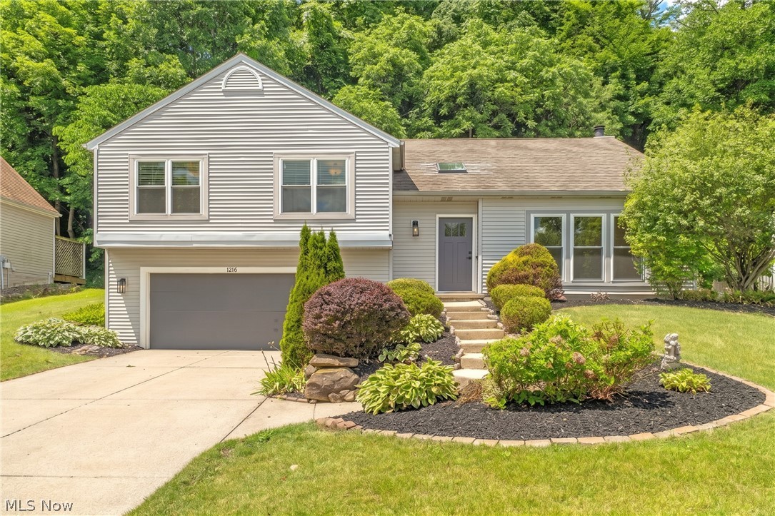 Welcome to this beautifully updated, move-in-ready home nestled in a desirable Twinsburg development with sidewalk-lined streets. From the moment you step inside, you are greeted by fresh paint and stunning new luxury vinyl plank flooring that flows seamlessly throughout the entire house. The spacious living room features soaring vaulted ceilings and a brand-new skylight that floods the space with natural light. The vaulted ceilings continue into the inviting family room, which is anchored by a cozy fireplace and offers direct access to the back deck. The chef of the family will love the bright kitchen, complete with all-new appliances. This home offers three generously sized bedrooms and two full bathrooms. Downstairs, the lower-level recreation room provides excellent additional living space and features new windows. Complete with a two-car attached garage and a peaceful, partially wooded backyard, this turnkey property is ready for its new owners to simply unpack and enjoy.