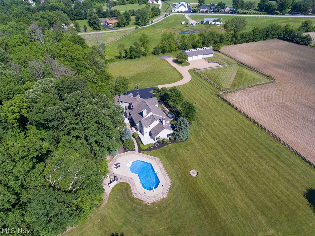 You'll be the envy of your neighbors with the manicured landscaping surrounding this 8,250+ SF home on 26+ acres. Features include 6 bedrooms, 5 bathrooms, captivating great room, master suite with sitting room and office, and walk-in closet. The distinguished dining room, captivating great room, and custom kitchen with breakfast bar for on-the-go meals! This just begins to describe this impressive property. There is an enormous room that could be used as a college students quarters, mother in law suite, or even plenty of space to let out of town family stay with you! The Horse barn with stables make for a great equestrian estate! The pond and sparkling inground swimming pool are two more spectacular features of this expansive property!