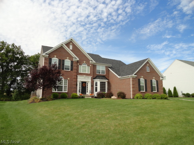 This 3450 Sq. Ft. along with the 942 Sq. Ft. finished lower level situated in desirable Spring Hill Development and Green Local School District make this a "Must See" home!  Hardwood flooring, Formal Living Room, Formal Dining Room with a Bay Window, Tray Ceiling, and Crown Molding, Family Room with a Gas Fireplace and tiled Hearth, decorating Ledge with molding, Kitchen with Maple Cabinets, Granite Counter tops, Wine Rack Cabinet, 1st Floor Office and Laundry, and a Window Seat with storage awaits your visit.  Take either one of the two staircases to the second level and enjoy the Master Bedroom Retreat with His/Her walk-in closets, tiled flooring in the Master Bath with double sinks, Garden Tub, and Tiled Shower.  There are 3 more bedrooms on the second level which share the Main Bath that has double sinks and laminate flooring.  The lower level was finished with style and includes a Billiard area, Theater area, and Play area for the kids complete with a blackboard chalk wall.  There