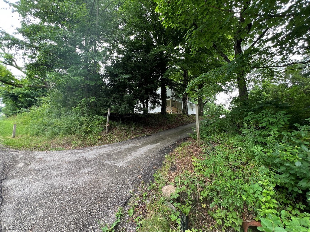This Beautifully updated home is secluded with wooded views that invite you to explore! The remodeled kitchen welcomes you home, with lots of counter space and cabinet storage. The cabinets are new and feature soft close drawers. All new carpet and paint throughout the home. The spacious bathroom offers unlimited storage and soft close drawers. So many opportunities with an enclosed 23 by 23 outbuilding and an open storage shed. The roof is new, some metal and the main roof features a synthettic slate shingle rated for 50 years but keeps the charm and style of this old farmhouse. A screened in gazebo sits in a shaded area and would be a great place to relax. Within minutes of downtown shopping, rogers flea market and Quaker city. Call your favorite agent and tour this charming home today