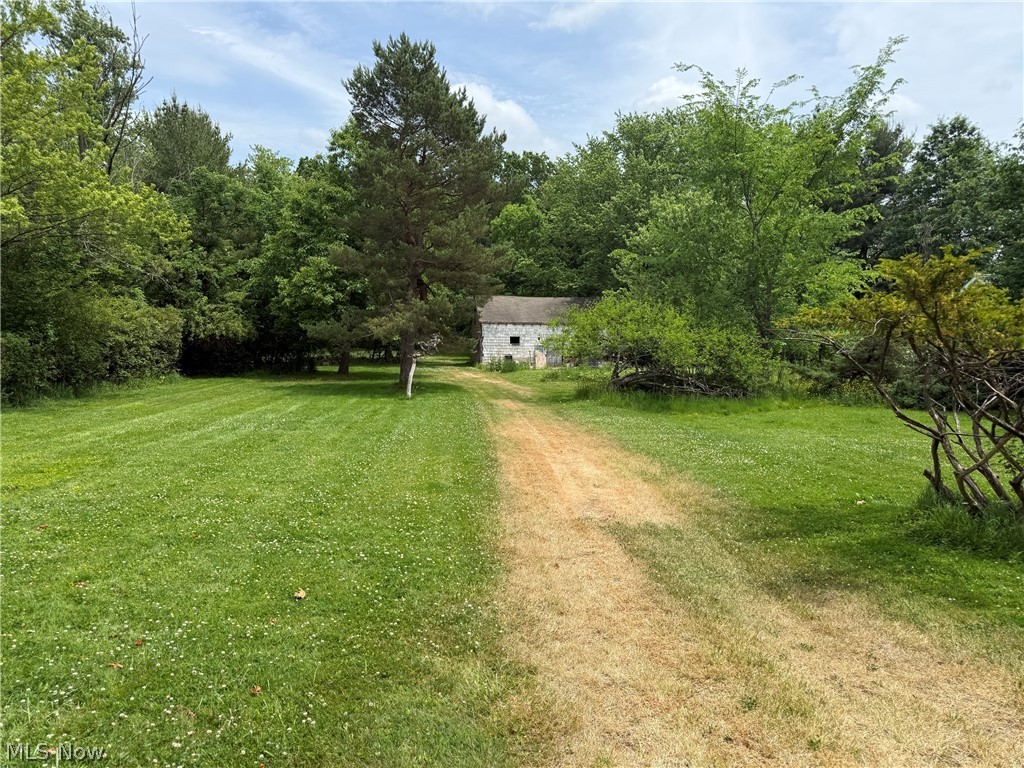 Rare opportunity in Solon with over 4.5 acres, an existing barn, and a 2-bedroom, 1-bath ranch ready for its next chapter. This is not a move-in ready home. The house needs a full clean-out and full rehab, so bring your contractor, builder, investor mindset, or renovation vision. The value here is in the land, setting, utilities, existing structures, and flexibility.

The home offers approximately 1,025 sq ft, plus a full unfinished basement, attached garage, enclosed porch, deck, hardwood floors, plaster walls, public water, public sewer, and forced-air heat. The lot is flat and deep, with approximately 116 feet of frontage and nearly 1,700 feet of depth, creating a private setting that is hard to find in this part of Solon.

The barn is a major bonus and gives the property added utility for storage, equipment, hobbies, or future plans, subject to buyer due diligence. Properties with this much land and an existing outbuilding do not come along often, especially in a convenient Solon location.

Renovate the existing home, explore a full rebuild, or hold the property as a long-term land opportunity. Buyers should verify zoning, building options, permitted uses, barn condition, utility condition, and all future plans with the appropriate local authorities.

Convenient location near freeway access, shopping, restaurants, Miles Market, Pinecrest, Ahuja Medical Center, University Hospitals, Cleveland Clinic facilities, and Solon Schools. A unique property with land, privacy, a barn, and real upside for the right buyer.