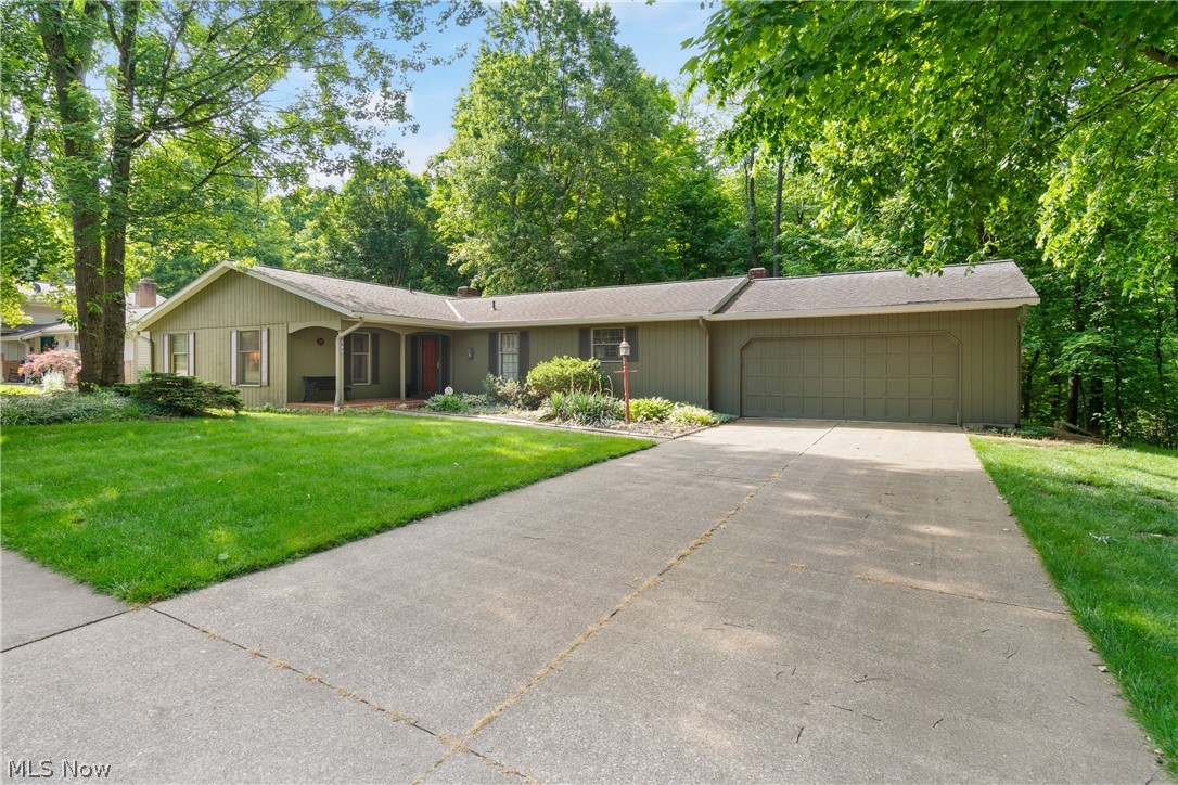 Nestled on a quiet street, this spacious ranch home offers the perfect blend of comfort, character, and entertaining space. The main level features two fireplaces and a stunning living room with vaulted beamed ceilings and expansive windows that frame peaceful backyard views. The open-concept kitchen and family room create a welcoming gathering space for everyday living and special occasions alike. The first floor includes four generously sized bedrooms, two full bathrooms, and a convenient half bath. The finished walk-out lower level expands the living space with a large recreation room, pool table area, bar, comfortable sitting area, and an additional half bath-ideal for entertaining family and friends. Enjoy the beauty and privacy of the wooded backyard while still having all the space and amenities needed for modern living. With the whole cedar exterior painted recently and the furnace and AC done in 2015, some of the major maintenance items are taken care of. This is a great house and you'll certainly want to come take a look!