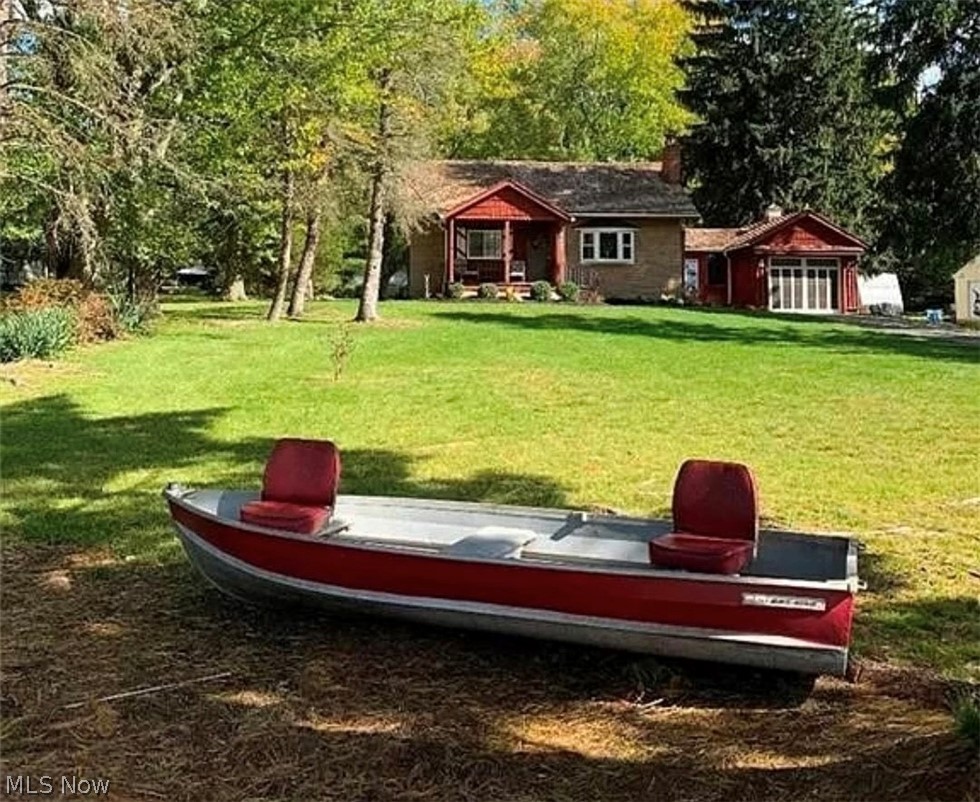 Looking for a piece of country nestled in Cuyahoga County with a Lake view?  Start your mornings with a cup of coffee on your covered from porch over looking a pond in the development. This home features a 1 car attached garage that has a morning room that is enclosed  that is attached in the home.  Inside the home you will find a renovated kitchen, 2 bedrooms with hardwood flooring, a full bath and a living room with a fireplace.  There is a spiral staircase that takes you to your 2nd floor loft area for plenty of entertainment space, or a wonderful office.  You will find a partially finished basement with room to entertain with a fireplace and bar.  There is also a 1/2 bath and a laundry room with an included newer washer and dryer.  Home features newer hot water tank.  Venture out back to your larger lot with an additional 2 car detached garage.