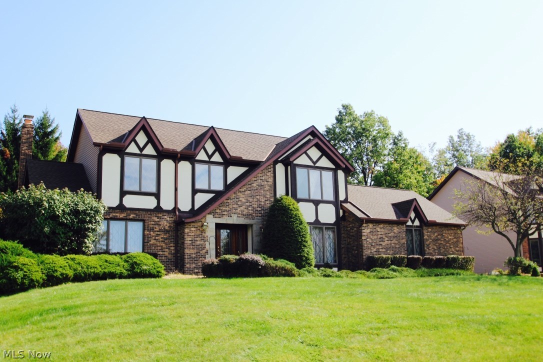 This gorgeous Tudor home w/ 4 bedrooms is built in the beautiful subdivision of North Royalton - Sherwood Highlands. Great location with beautiful neighborhood with manicured lots, perfect for walking pets. Award winning school system. Convenient location to all kinds of shopping and walking distance to a new YMCA. Sprawling 62' Front Elevation w/Side Entry Garage on .3863 Acre Lot with multi level deck. Tiled 4-season Room with Hot Tub and beautiful wood vaulted ceilings. Finished Basement, Anderson Windows. Huge family room w/ fireplace that opens up to the kitchen. Newer granite in kitchen with Stainless Steel appliances. Formal Living & Dining Rooms! First floor laundry, and Over Sized Owners Suite with vaulted ceilings and glamour bath with whirlpool bathtub. Security System, Central Vac, newer roof, hot water tank and furnace. Spacious yard.