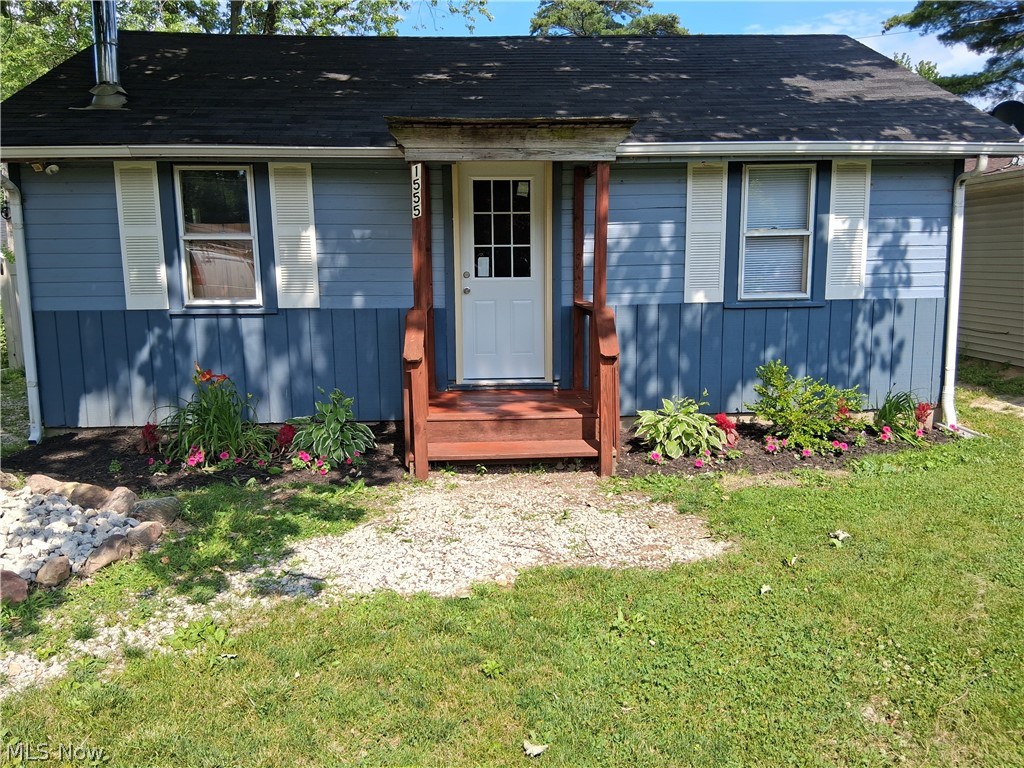 Tucked away in a peaceful setting, this charming 588 square-foot home at 1555 Glenview Ave in Madison offers cozy comfort with rustic character throughout. Lake Erie public access. Featuring 2 bedrooms and 1 bathroom, the home showcases a spacious remodeled great room and kitchen with warm knotty wood paneling and soaring vaulted ceilings that create an open, inviting atmosphere. NEW LPV floors. Stainless steel chimney pipe installed through roof for wood burner connection. A versatile laundry room provides additional flex space and could easily function as a second bedroom, office or guest area. Thoughtfully updated while maintaining its cabin-like charming, this property is perfect as a full-time residence, weekend retreat, or investment property.