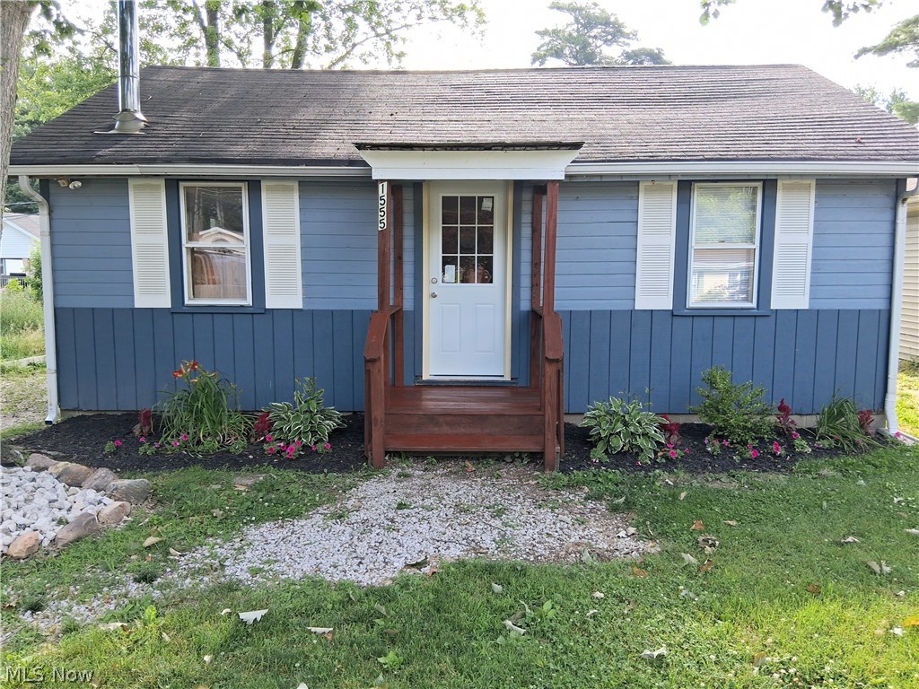 Tucked away in a peaceful setting, this charming 588 square-foot home at 1555 Glenview Ave in Madison offers cozy comfort with rustic character throughout. Lake Erie public access. Featuring 2 bedrooms and 1 bathroom, the home showcases a spacious remodeled great room and kitchen with warm knotty wood paneling and soaring vaulted ceilings that create an open, inviting atmosphere. NEW LPV floors. Stainless steel chimney pipe installed through roof for wood burner connection. A versatile laundry room provides additional flex space and could easily function as a second bedroom, office or guest area. Thoughtfully updated while maintaining its cabin-like charming, this property is perfect as a full-time residence, weekend retreat, or investment property.