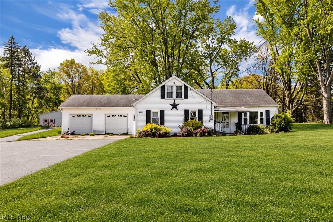4556 Warren Sharon Road in Vienna is a home full of potential, set on an impressive 12.88 acre property offering space, privacy, and endless possibilities. Whether you are looking for room to spread out, space for hobbies and equipment, or simply a quieter setting surrounded by nature, this property offers a rare opportunity to create something truly special over time. While the home carries some original finishes, it has been well cared for and remains completely livable, making it an ideal option for someone looking to move in while gradually adding their own updates and personal touch. Inside, the living room welcomes you upon entry and flows naturally into the casual dining area and kitchen, creating an easy everyday layout. Sliding glass doors off the dining space lead directly into one of the home’s two all weather rooms, offering a bright sunroom style space perfect for morning coffee, reading, or relaxing year round. The kitchen offers solid bones with abundant built in cabinetry and plenty of workspace, while the dedicated laundry room just off the kitchen adds convenience and functionality. A second enclosed patio or all season room creates even more flexible living space and could easily become a hobby room/office, sitting area, or entertaining space. The home features 2 bedrooms and 1 full bathroom. The bathroom is generously sized and includes both a standup shower and separate soaking tub, offering a layout rarely found in homes of this size. Outside, the attached 2 car garage and large barn provide exceptional storage, workshop space, or room for equipment and recreational use. A unique property with acreage, charm, and incredible potential for someone ready to bring new life into a home with strong bones and a beautiful setting.
