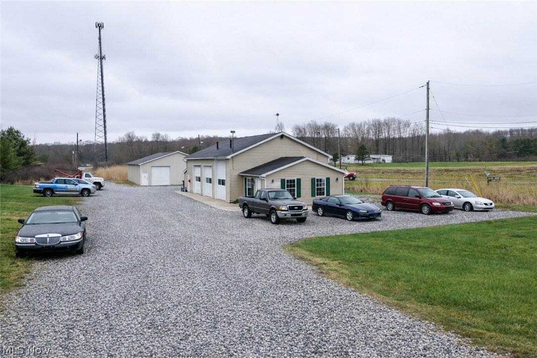 Turnkey Auto/Shop + Investment Property. A Ready to Run Business  For the first time in 36 years, this well-established commercial property is hitting the market. Set on 3.71 acres in Garrettsville, 10320 Brosius Rd offers the kind of setup that's hard to find, two solid buildings, a proven location, and room to grow. Both buildings consist of over 4,200 sq ft. 
The front building (48x32 pole building with block construction) features three bay doors- one 12' and two 10' plus a loft for additional storage. Inside you'll find an air-conditioned front office addition and an additional office off the garage. Includes Two Twin Post Challenger Lifts at 12,000 lb capacity each & an Ingersoll air compressor. 

The back building (40x60) adds a 10' garage door and plenty of open space for equipment, storage, or additional work bays. The back building is already wired with phone and electric for additional offices. Both buildings are well-maintained & ready to go.

The property runs on 200-amp service. Updated vinyl siding (2023), vinyl windows, fiberglass entry doors, & a roof with no known issues round out the exterior. Additional systems include a Gemini alarm system, Panasonic phone system capable of 10 lines, & an intercom/PA system. 

Cell tower located on the east portion of the property. No lease and no royalties associated with the tower.
There is an easement over the southern parcel that provides additional driveway access and turnaround space for the parcel being offered for sale.The southern 1.54-acre parcel is not currently included in this sale. It is presently used by Village Motors Towing for storage & operations & may be offered separately in the future as an investment opportunity.

Whether you're an auto mechanic, machine shop operator, car dealer, or investor looking for a versatile commercial property with built-in infrastructure, this one checks the boxes. Includes both buildings & all major equipment. See you tube for video.