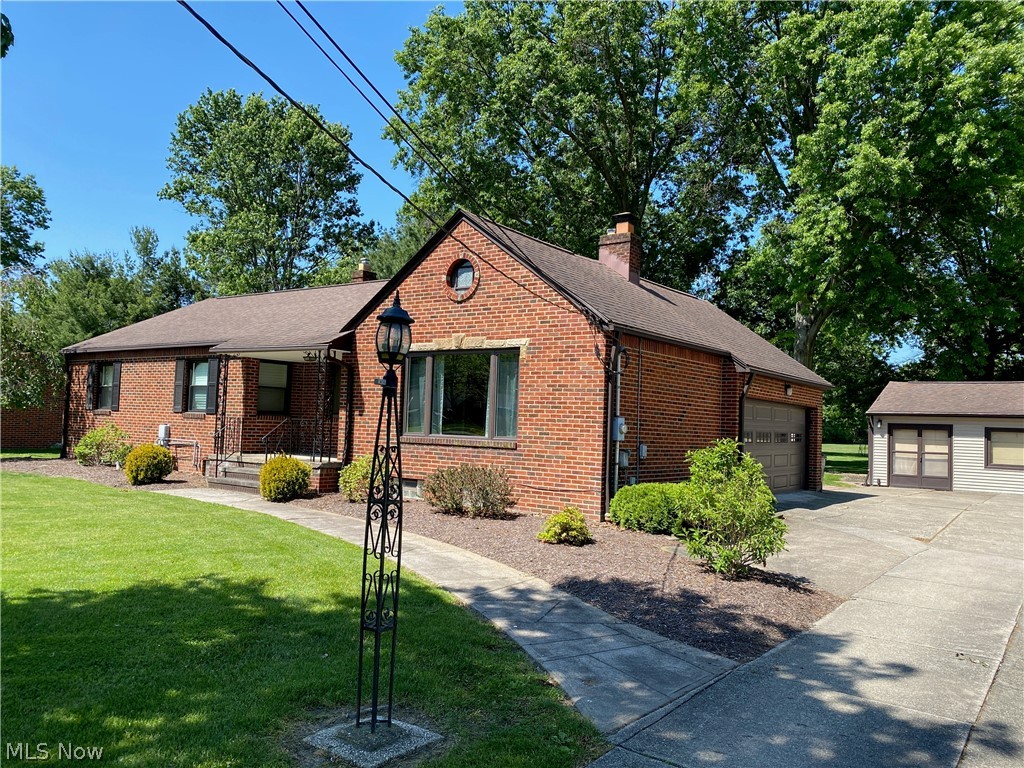 This charming 3 bedroom brick ranch sits on more than 2 beautifully manicured acres, offering privacy, serenity, and endless possibilities.The spacious kitchen showcases the owner's exceptional craftsmanship with stunning custom cherry cabinetry, stainless steel appliances and a wood floor. It also boasts 3 comfortable bedrooms, 1.5 baths, and generous living and dining spaces designed for everyday comfort and entertaining. The basement has a stand up shower, a laundry area, and a large room for your workout equipment or whatever else you see fit.  Step outside to enjoy the expansive patio overlooking the gorgeous property, perfect for relaxing and hosting family and friends. Another standout feature is the impressive 29X20 outbuilding, which is equipped with gas service and 100AMP electrical service. Whether you're a car enthusiast, gardener, hobbyist, looking for a man cave, a workshop, a home office, or exploring possible multigenerational  living options this versatile space offers tremendous potential. Oh, and did I mention there is another outbuilding, perfect for storing your cars or gardening equipment? You'll be impressed! Additional highlights include a brand new septic system installed in 2025, a recent land survey, and the property backs up to a local golf course. This one-of-a-kind property offers the perfect blend of country-like tranquility, functional space, and opportunity.