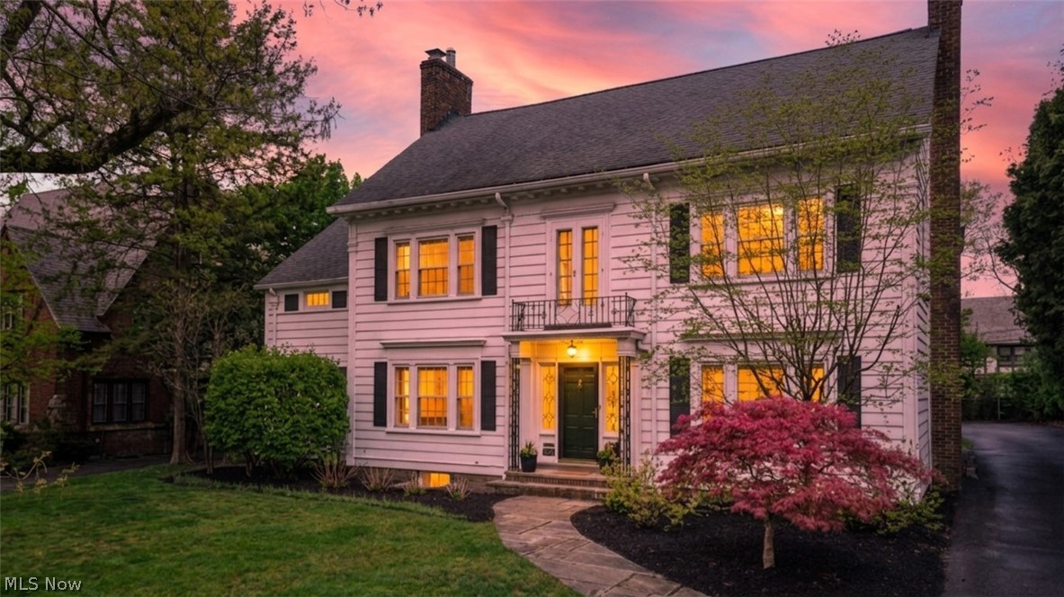 Perched gracefully on a hill in the highly sought-after Malvern neighborhood of Shaker Heights, this storybook center hall colonial delivers timeless charm, exceptional curb appeal, and an unbeatable location. A stunning Japanese maple beautifully frames the home, setting the tone before you even step inside. The welcoming center hall foyer opens to a spacious living room, a cozy office or TV room, and a delightful screened-in porch—perfect for relaxing evenings. To the right, a generous dining room flows into the updated kitchen, which features butcher block countertops, stainless steel appliances, a farmhouse sink, and a versatile eat-in counter ideal for casual dining or working from home. A convenient powder room completes the first floor. Upstairs, the elegant staircase leads to a landing adorned with leaded glass windows, adding a touch of classic character. The second floor offers four well-appointed bedrooms with hardwood floors and ample storage. The front-facing primary suite includes an en-suite bathroom and walk-in closet, while two bedrooms share a charming Jack and Jill bath. The third floor provides a flexible full suite with two additional bedrooms, a shared full bath featuring a clawfoot tub and shower surround, and abundant storage space. The lower level features a finished recreation room along with a clean mechanical and laundry area finished with Nature Stone flooring. Outside, the private backyard is perfect for entertaining or everyday enjoyment, complete with a stone patio, raised garden beds, and plenty of green space. A solid two-car garage with a new door adds to the home’s functionality. Additional highlights include central A/C, a working fireplace, Alexa-controlled exterior lighting and security, and abundant natural light throughout. Ideally located moments from Van Aken District, Shaker Heights CC, Thornton Park, and the RTA Rapid Transit, with quick access to highways and downtown, this home truly offers the best of Shaker living.