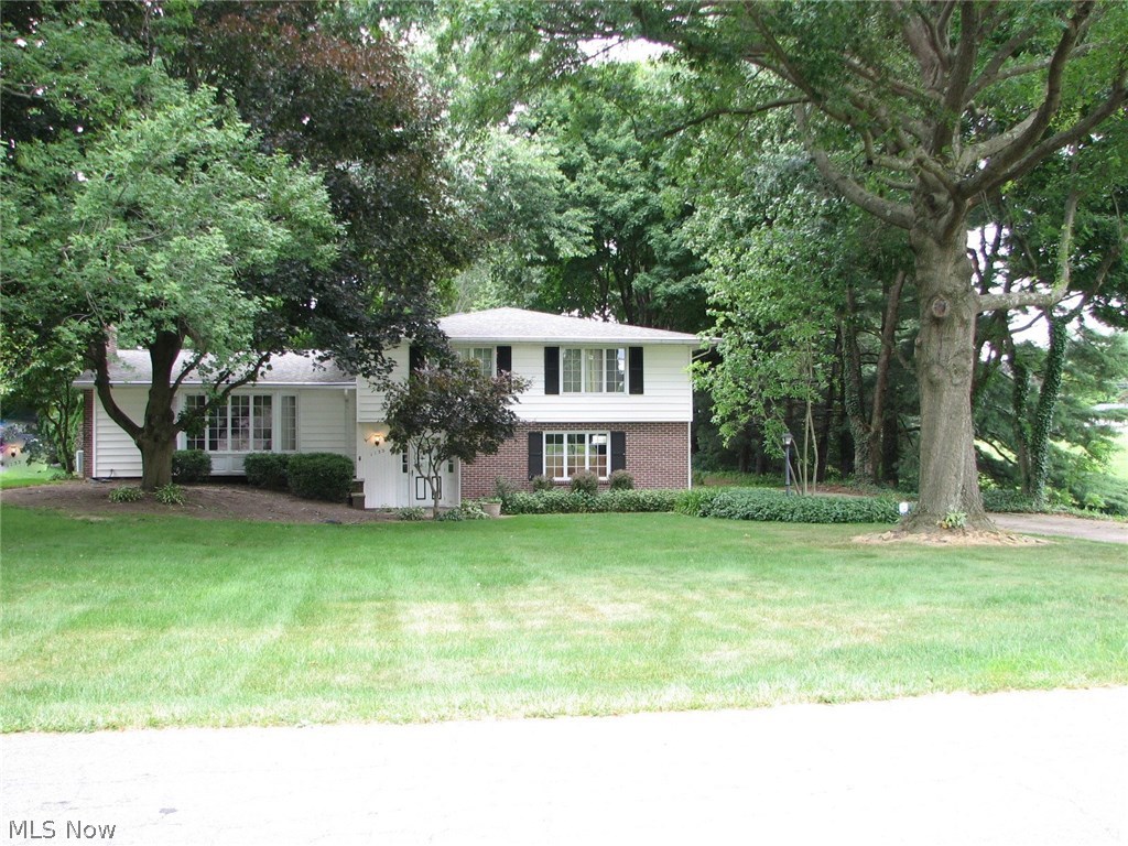 Come inside and take a look at this spacious 4 level split.  Special features include a cathedral ceiling in the living room with fireplace, a family room/den leading to the heated and cooled sunroom, and a master bedroom with private bath, double closet and a walk in closet!  There is no lack of storage and closet space throughout.  The kitchen has a solid surface counter top, lots of cupboards and comes with appliances.  You'll love the layout and large rooms.  The two car garage has an attached workshop.  Wonderful park-like, peaceful setting on a double lot in the heart of Perry near Summerdale Park and the Exploration Gateway at Sippo Lake.