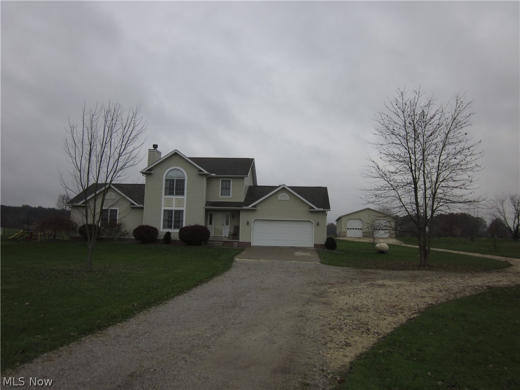 SPACIOUS 2 STORY with 4 bedrooms, 3.5 baths.   First floor owners suite and first floor laundry room, living room with fireplace, family room with pellet stone.   2.5 car attached garage plus a newer 40 x 64 outbuilding, concrete floor and car lift built in 2011 approx.  Beautiful brick patio.  OVER 2 ACRES!