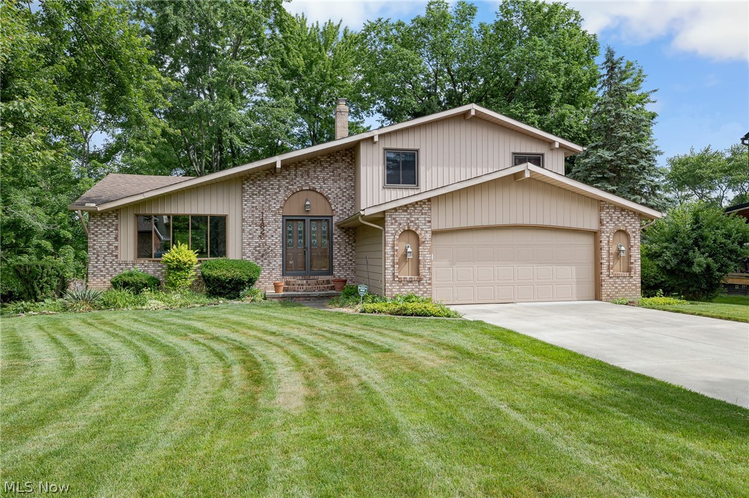 Welcome home to this lovely 3 bedroom split-level nestled on a quiet cul-de-sac with wooded views in the heart of Strongsville! Beautifully manicured landscaping and a warm, neutral exterior create inviting curb appeal from the moment you arrive. Step inside the impressive two-story foyer featuring a stunning curved staircase that sets the tone for the rest of the home. The spacious living room flows seamlessly into the dining room, providing the perfect layout for entertaining family and friends. The eat-in kitchen is well-appointed with wood cabinetry, granite countertops, decorative backsplash, and included appliances. Just a few steps down, you'll find a cozy family room highlighted by a fireplace, creating the ideal space to relax and unwind. A convenient powder room and laundry room complete the main level. Upstairs, you'll discover 3 comfortable bedrooms and a nicely updated full bathroom. The basement offers ample storage space and is ready for your finishing touches should you desire additional living space. Outside, enjoy the large patio overlooking peaceful wooded views, a storage shed, and plenty of yard space for outdoor activities, gardening, or entertaining. Conveniently located near shopping, restaurants, schools, parks, and quick highway access. Don't miss this wonderful opportunity schedule your private showing today!