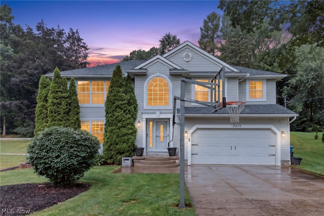 Welcome to 3470 Madora, situated on a beautiful 0.58-acre lot in the highly desirable Green Local School District. Step through the front door into an impressive two-story foyer featuring granite accents and soaring 16-foot ceilings. To the left, you'll find a versatile sitting room with an electric fireplace, perfect for a home office, reading room, or additional living space.
Hardwood flooring leads into the updated kitchen, complete with granite countertops, a large island with shiplap detailing, subway tile backsplash, and built-in lockers for added organization. Just off the kitchen is a convenient mudroom and first-floor laundry.
Step outside to the expansive composite deck overlooking the heated pool and spacious backyard, an ideal setting for entertaining family and friends all summer long.
Upstairs, you'll find three generously sized bedrooms, each with its own walk-in closet, along with two full bathrooms. A 14' x 14' loft provides the perfect flex space for a playroom, media room, or home office, and could easily be enclosed to create a fourth bedroom if desired.
The finished basement adds approximately 575 square feet of additional living space and features a granite-topped bar that is already plumbed for a wet bar, creating additional living space.