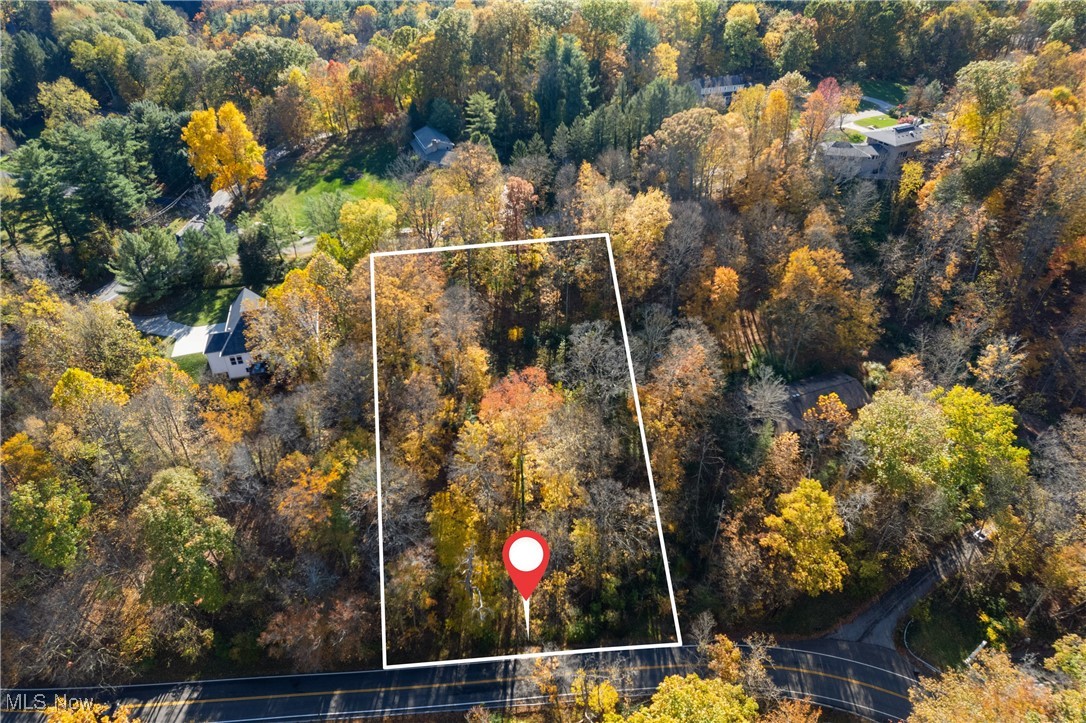 Rare opportunity for a 1.32 acre building lot in an established neighborhood in beautiful Bath Twp.  Scenic hilltop location on a quiet park-like setting surrounded by forest.  Monthly HOA fee includes Oak Knoll’s EPA regulated private sewer & water system.  Wonderful privacy and views to build your dream home.  Bring your own builder, or full plans are available for a custom hilltop home from the current owner’s builder.  Lot is accessed from a private driveway located just West of the front of the lot on Revere Rd.  Lot has frontage on Revere Rd and Oak Knoll Dr.