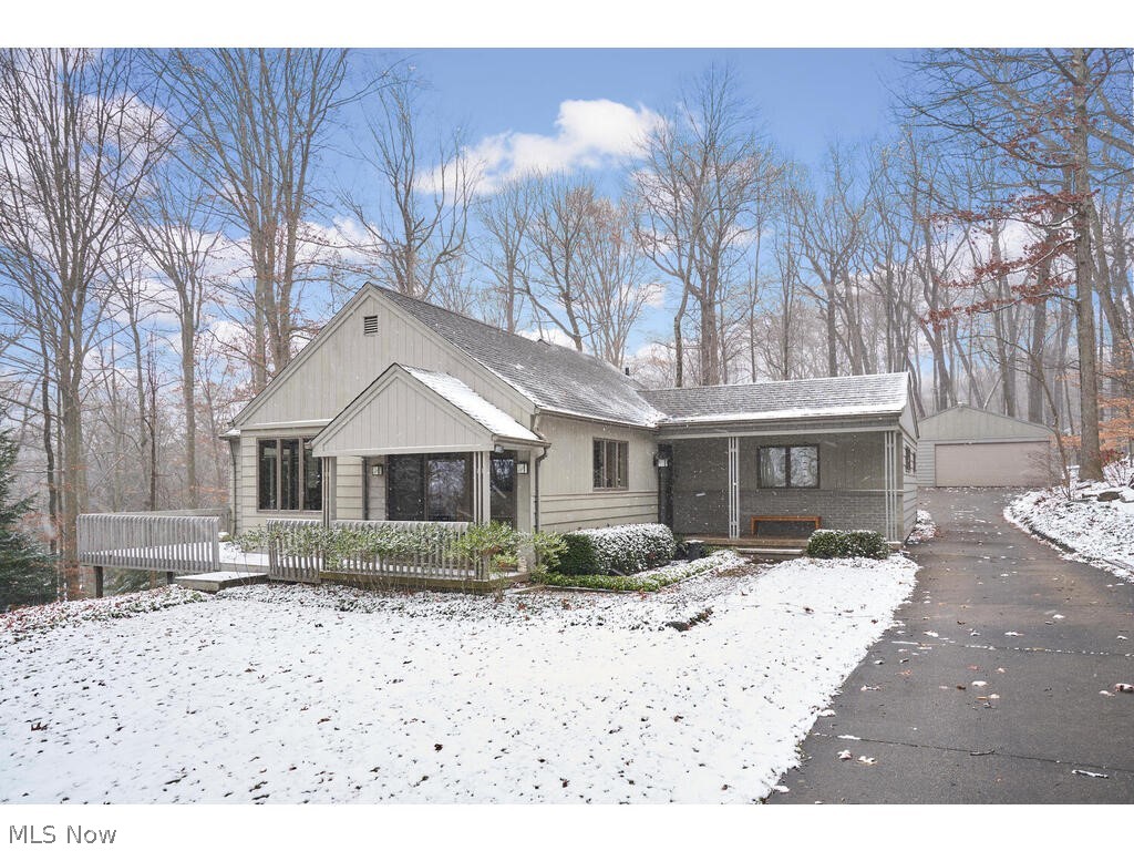 This meticulously maintained ranch sits on 3.45 acres of glorious woods featuring your own mini "ledges trail"! This one of a kind home is ideally situated and features an abundance of windows and sliding glass doors to give you a view from every room. A long cement drive will lead you to this private wooded sanctuary. The inviting covered front porch will open into the foyer that leads you to the enormous living room! Not only is the size impressive but note the marble tiled fireplace, hardwood floors and natural light! The dining room is open to the living room and is surrounded by a wall of windows and a slider leading to a spacious deck. Cooking will be no longer be a chore in this light and bright kitchen that offers tons of cabinet and counter top space. Quiet time can be enjoyed in the separate family room that is located in the back of the house where you can also find the 3rd bedroom and 3 season Sunroom! Floor to ceiling windows in the sunroom brings in the captivating views