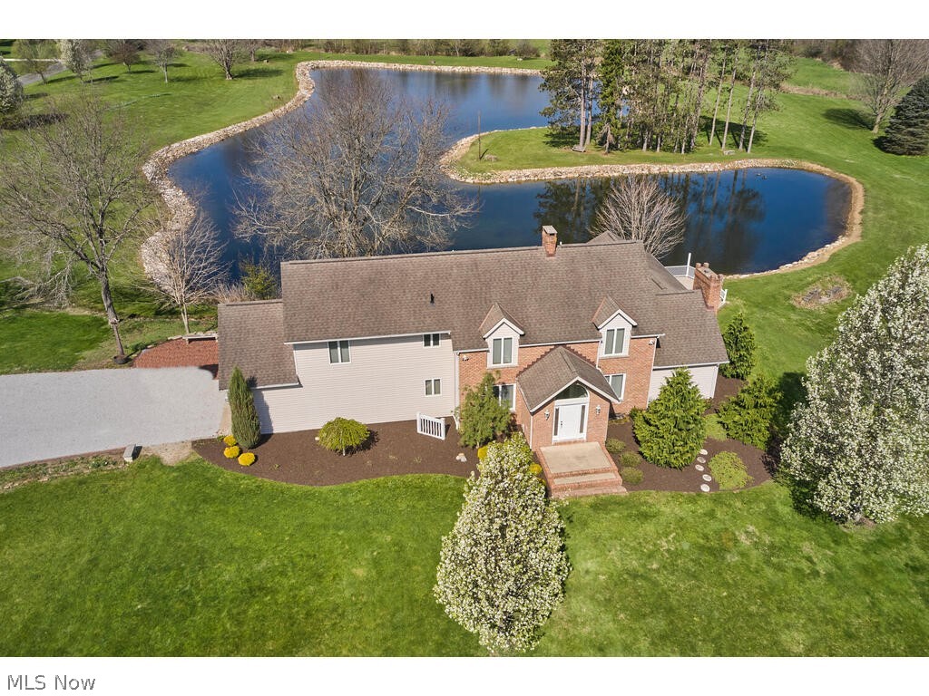 Most picturesque property in Granger Township, this parcel offers 16.4 gentle rolling acres with 2-3 acre stocked lake.  Fabulous potential to split off 2 lots (one already surveyed) and keep existing home.  Build your dream home while living in the current home.  Lots of frontage on both Medina Line Rd and Waterside Dr. Georgian colonial home has had 2 additions.  First floor highlights spacious eat in white kitchen, formal dining room, and formal living room with fireplace.  Additionally, there is a large family room featuring wall of windows and french doors to Florida room.  First floor library boasts a wall of built-in bookshelves and gas frpl. The second floor presents three sizeable bedrooms including the owners suite with newer full bath, and a second renovated full bath.  Fantastic views out of every window.  Expansive trex deck overlooking water.  Large extra outbuilding was once a rented cottage and now serves as storage with covered front porch and separate septic. Main hom