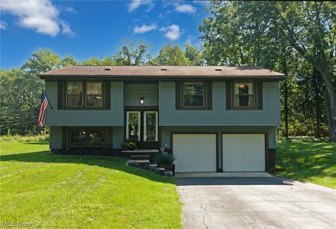 An exceptional Kent bi-level that has been completely remodeled.  This 3 bedroom home has an open concept with the kitchen having been opened to the living room and dining room.  A large 23x12 family room and half bath are in the lower level.  The many updates include the kitchen, baths, flooring, electric panel ('22), furnace ('21), a/c unit ('21), hot water tank ('21), and vinyl siding ('22).  Amazing wrought iron style railings, with built in gates, are in the foyer and living room area.  A newer composite 2 tier deck is 24x12 main level, with a hot tub ready lower deck as well.  A large yard with privacy to the rear, a shed, 2 car garage, and so much more.