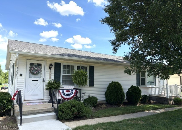 This cottage style condo feels like a home inside and out!  Don't let the square footage fool you...this condo lives big!   Plenty of space upon entering whether from the front or the private garage beneath.  This plan makes sense and the owner makes good use of all the space!  The welcoming front porch opens to the charming living room, kitchen and dining area with a new peninsula bar with seating.  The newer, laminate floors flow throughout the living area and bedrooms.  The two bedrooms are good size and the bath features a shower, ceramic tile and is light and bright. Ceiling fans are throughout. Electric heat (no gas bill) and central air (2025).  The roof is the association responsibility and just five years old.  Beautiful new laundry area in basement with built-ins.  Hot water tank was replaced in 2018.  Awesome sitting area setup (15x9) in garage and actual garage parking/storage area is 13x31 and spacious enough for a truck or larger suv.  Lovely, park like setting in front with additional parking and a peek of the community clubhouse and pool.